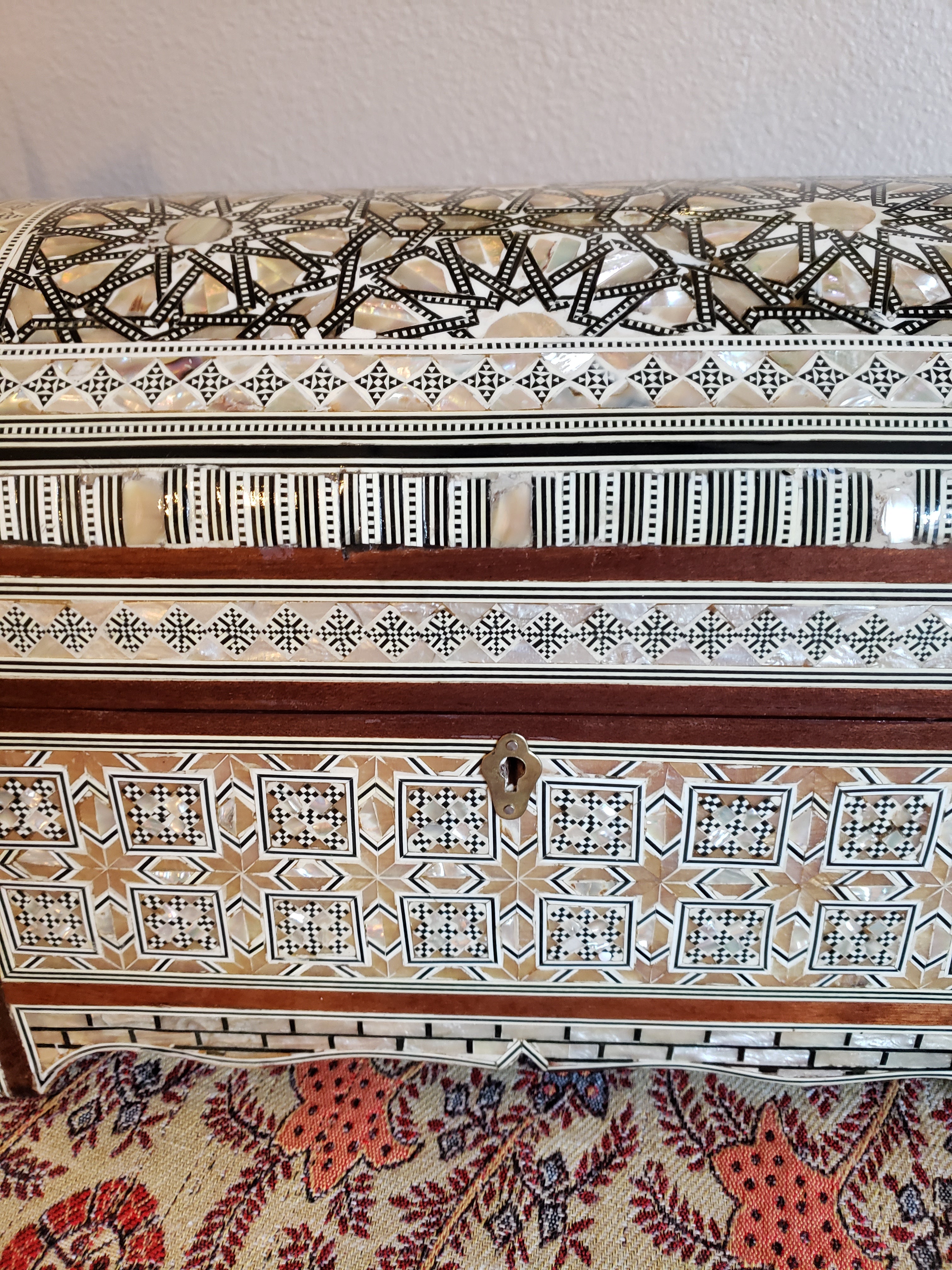 Decorative wooden box with intricate patterns on a plain background