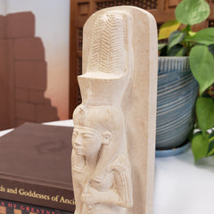 Decorative stone shelf with carvings in a home setting
