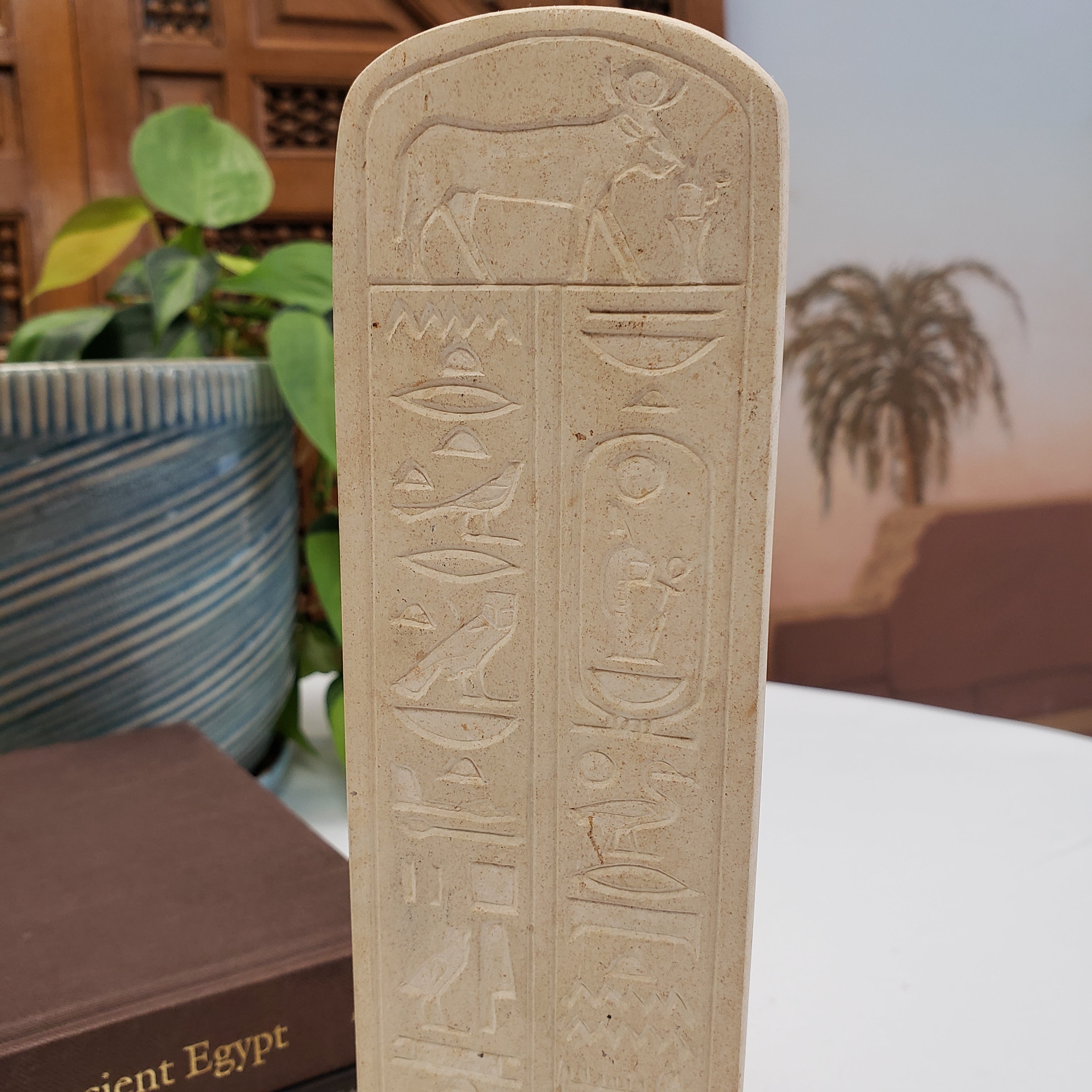 Decorative item with ancient Egyptian hieroglyphics on a blurred background