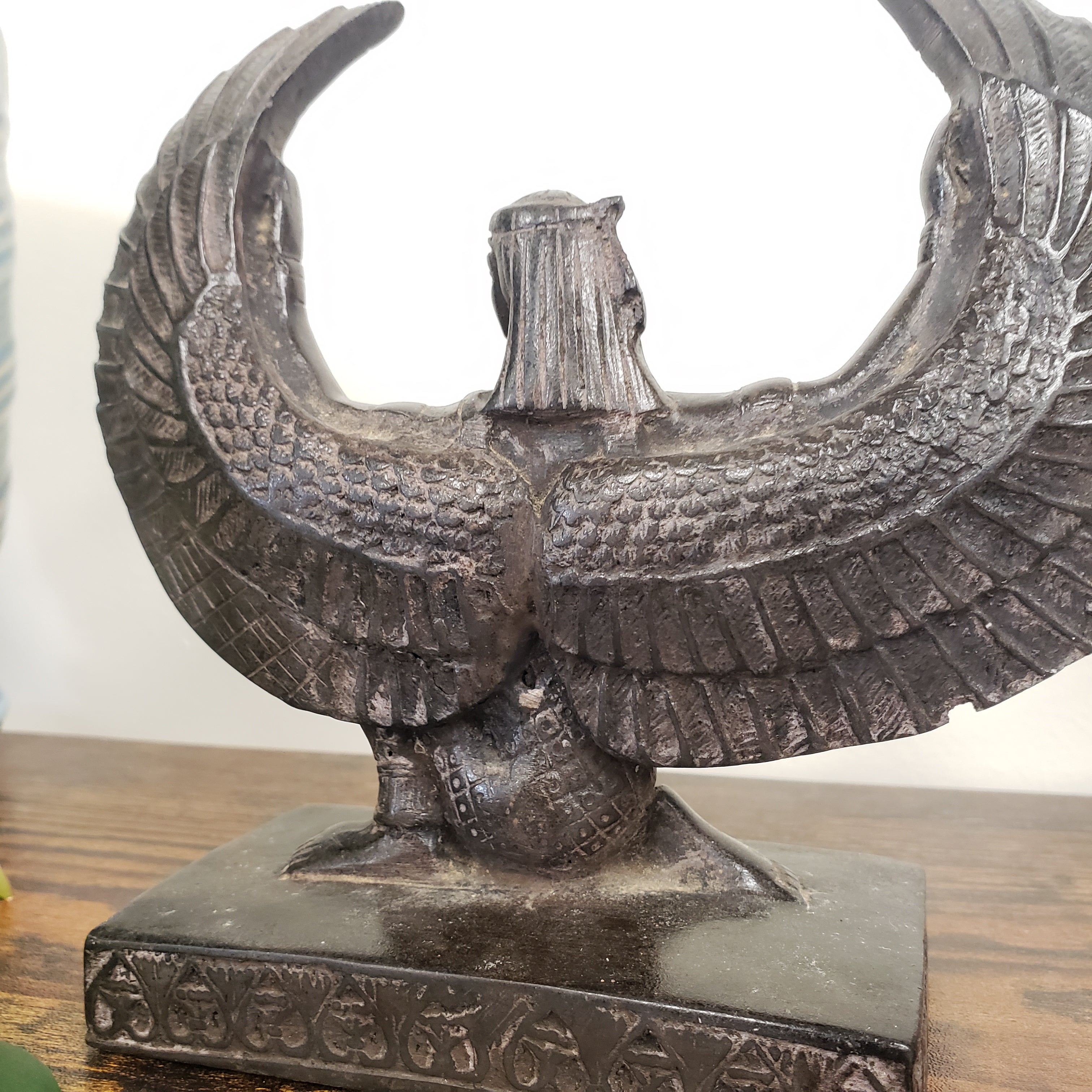 Decorative Egyptian Isis statue on a wooden stand