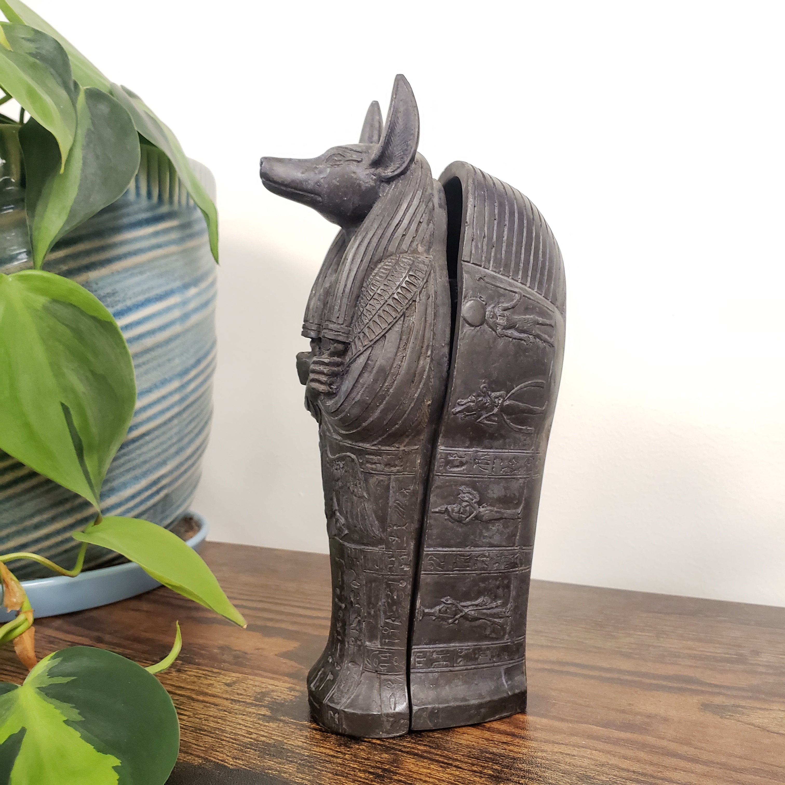 Decorative Anubis object with intricate carvings on a white background