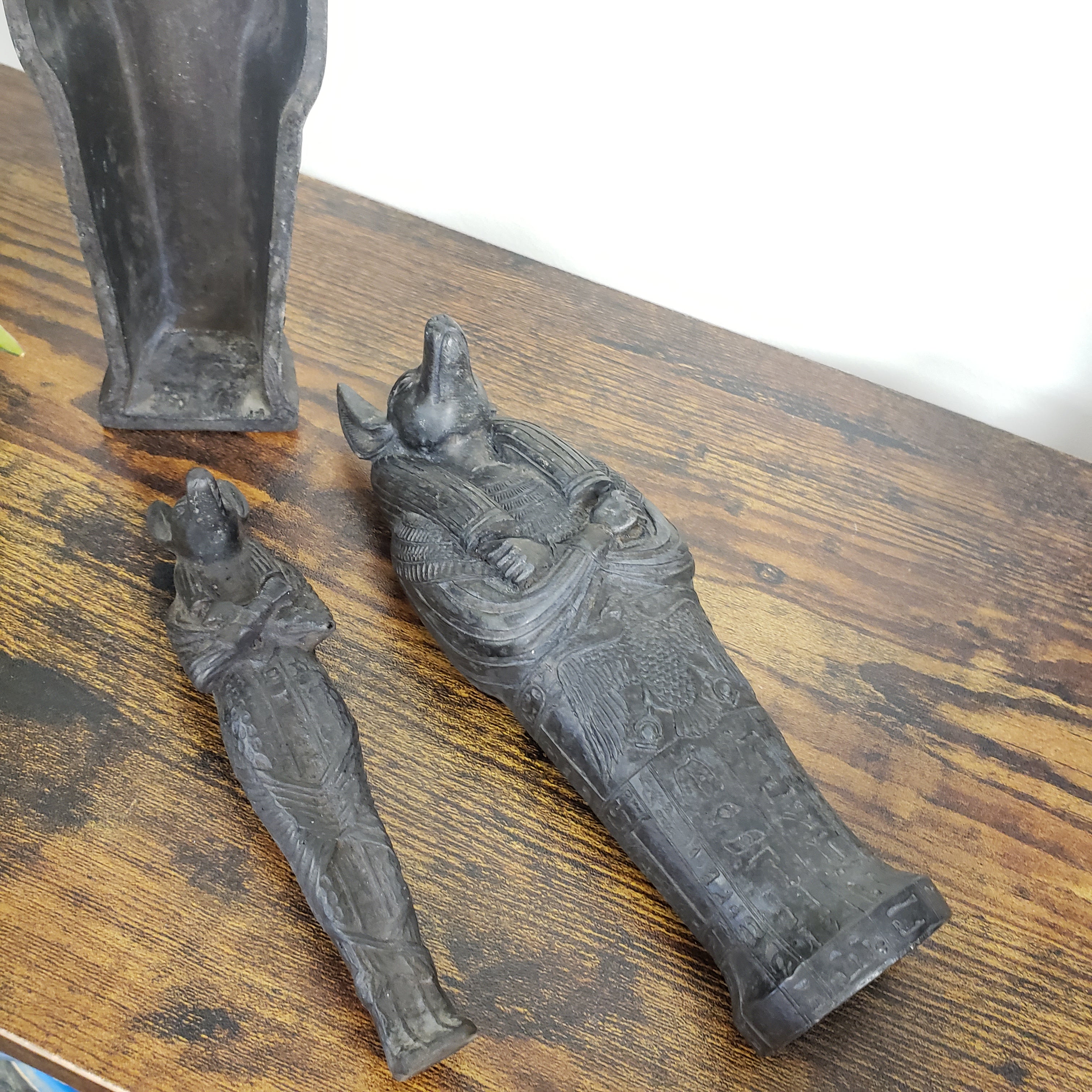 Decorative Anubis with intricate designs on a wooden surface