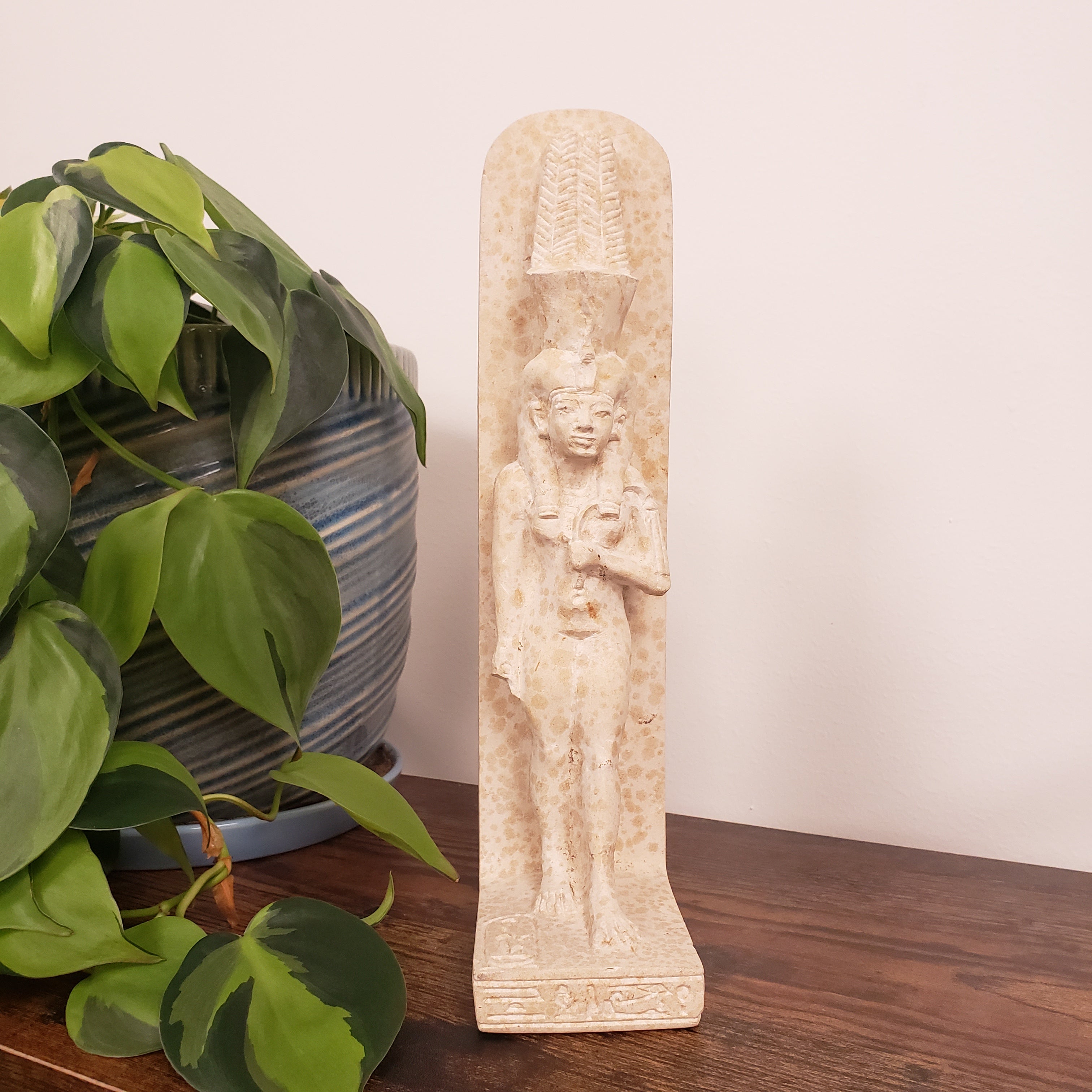 Decorative stone statue of Tiye on a white background