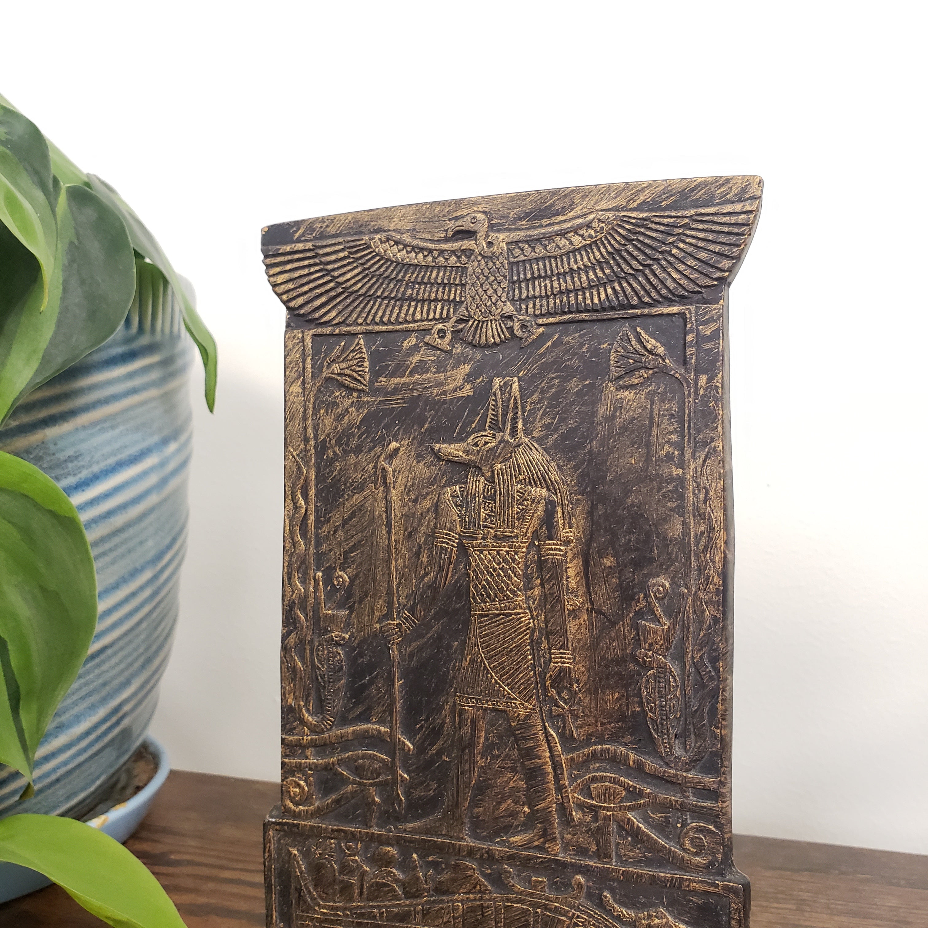 Decorative Anubis plaque with carvings on a white background