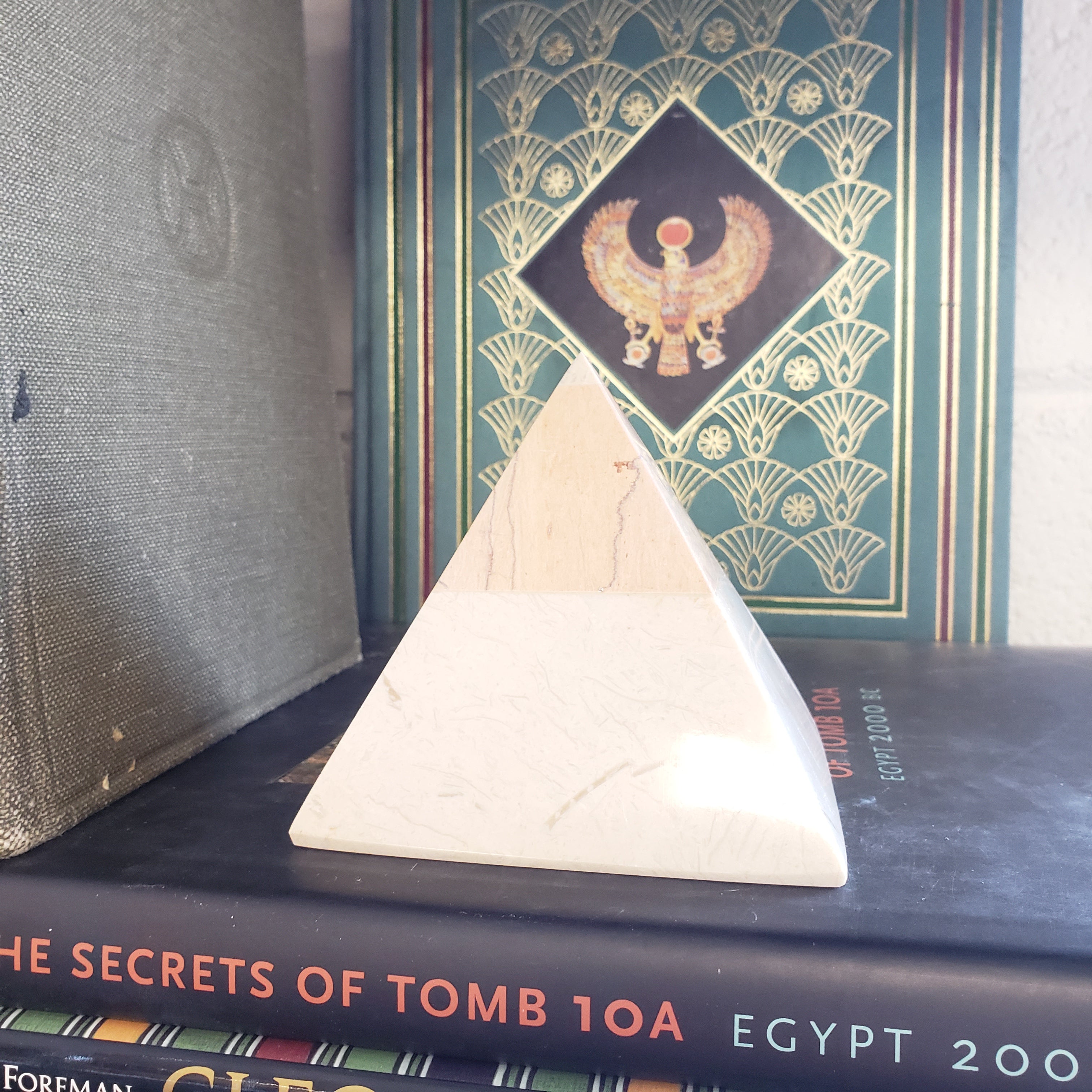 marble pyramid art piece on a textured surface