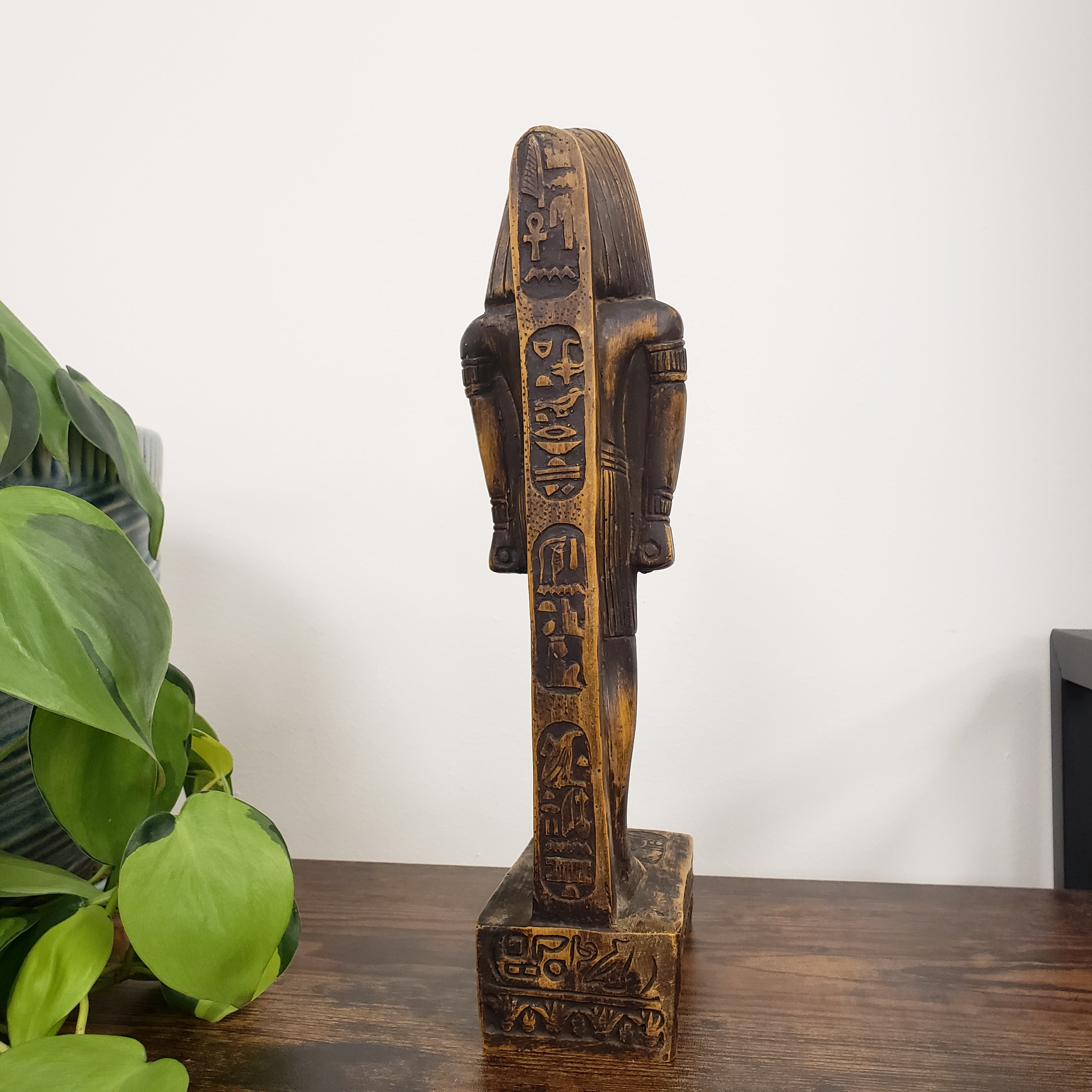 Egyptian god Thoth sculpture with intricate carvings on a white background