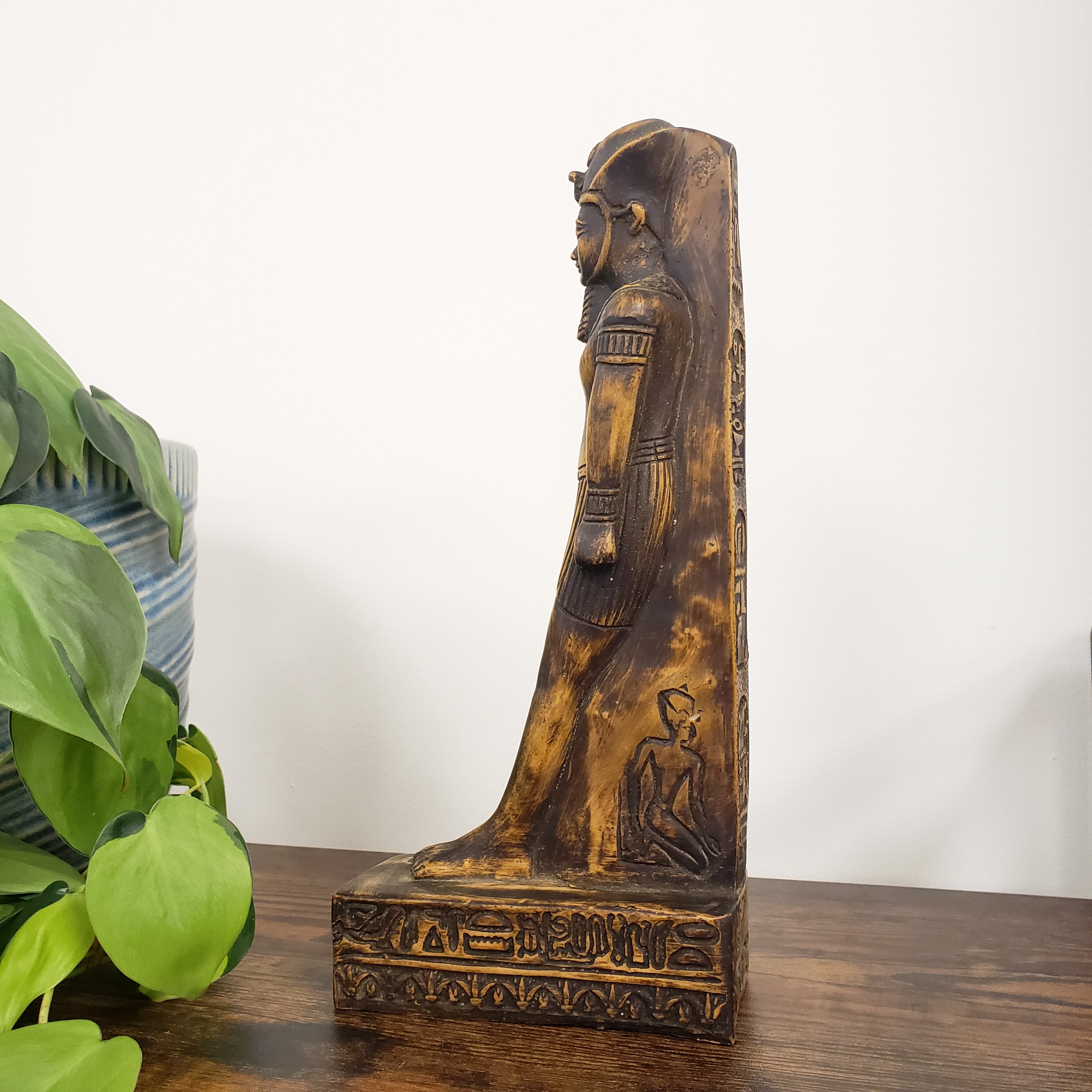 Decorative King Amunhotep Statue with intricate carvings on a white background