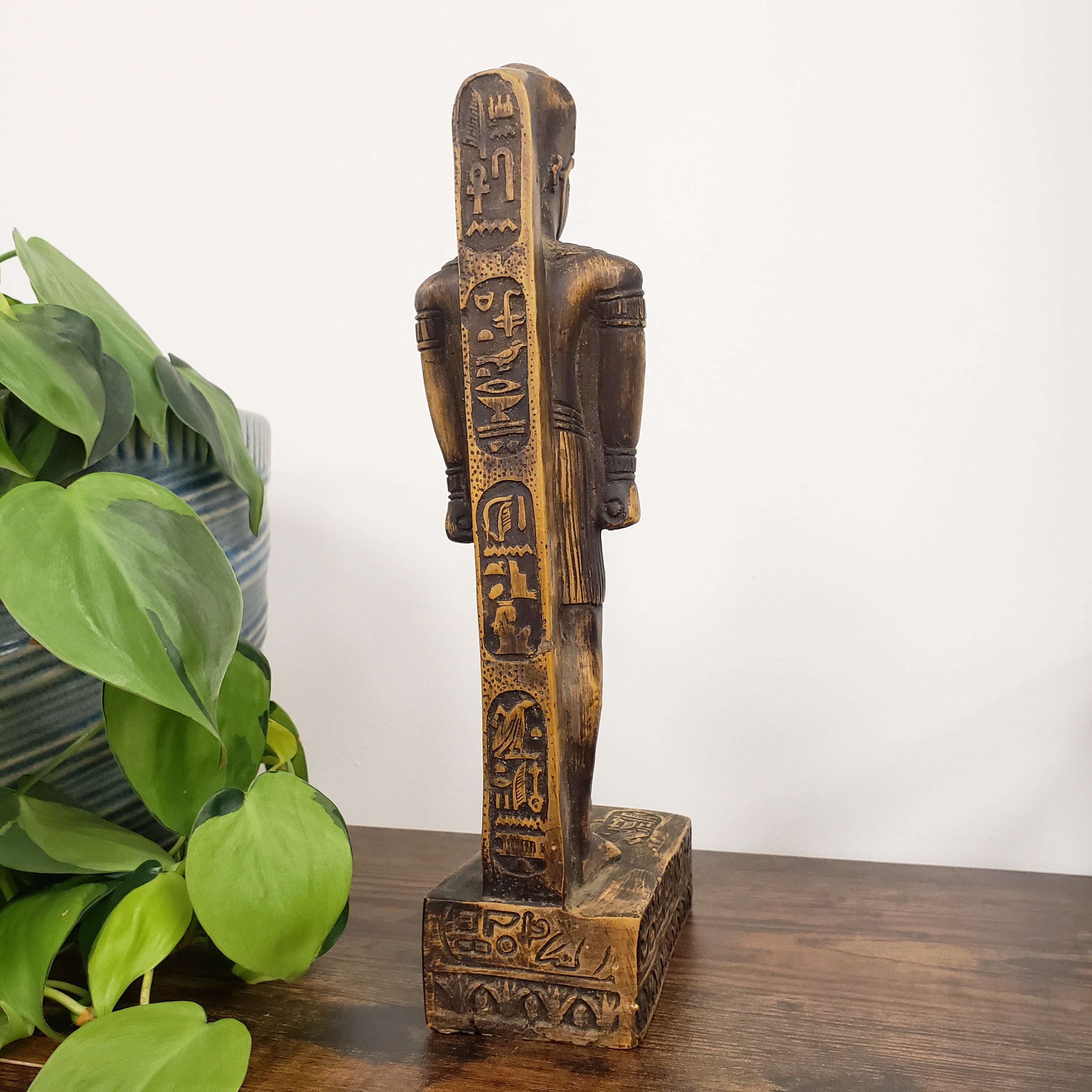 Decorative King Amunhotep Statue with intricate carvings on a white background