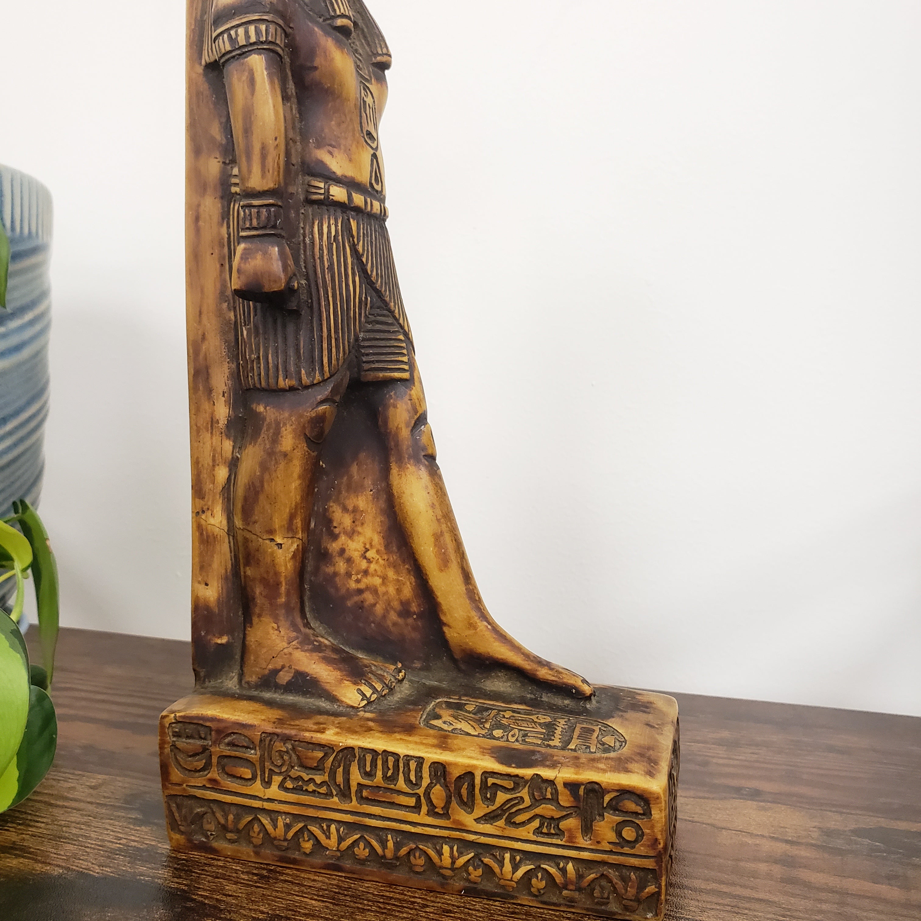 statue of the Egyptian god Anubis with intricate carvings on a white background