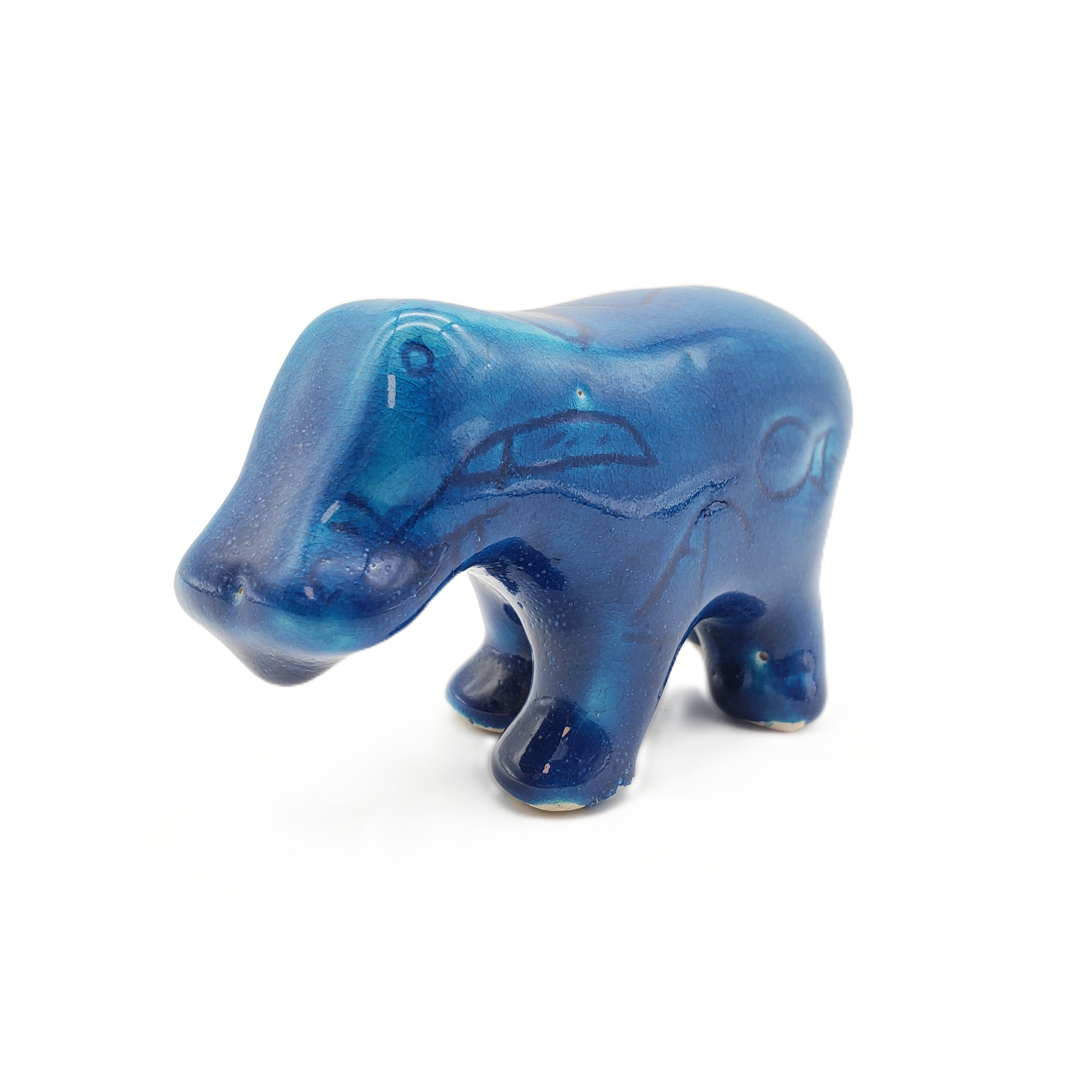 Blue ceramic hippo figurine on a white background