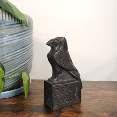 Decorative falcon with carvings on a wooden surface