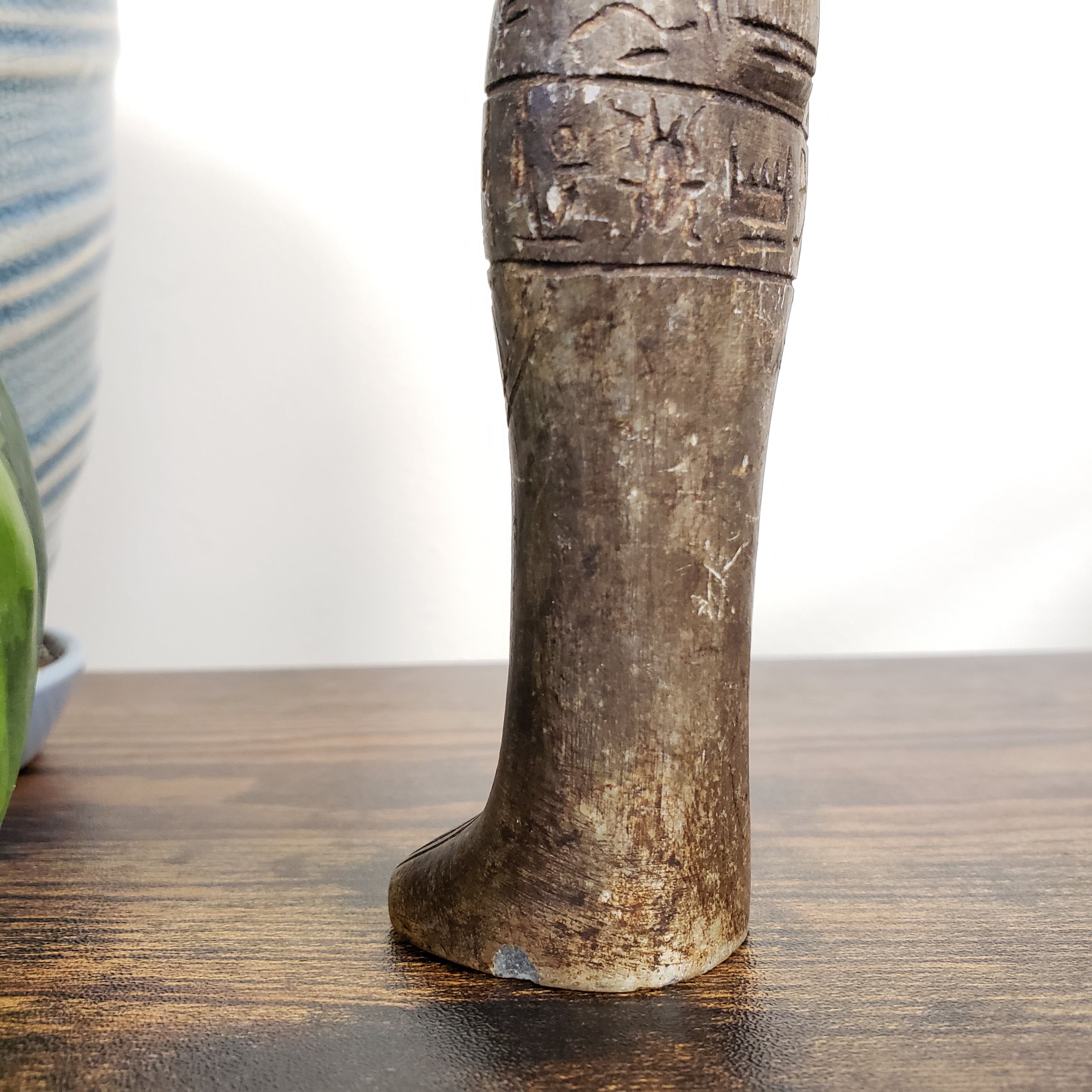 Close-up of a Egyptian Anubis statue with texturing details on a blurred background