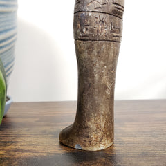 Close-up of a Egyptian Anubis statue with texturing details on a blurred background