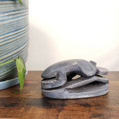 Decorative sculpture of a scarab on a wooden surface with a blurred background