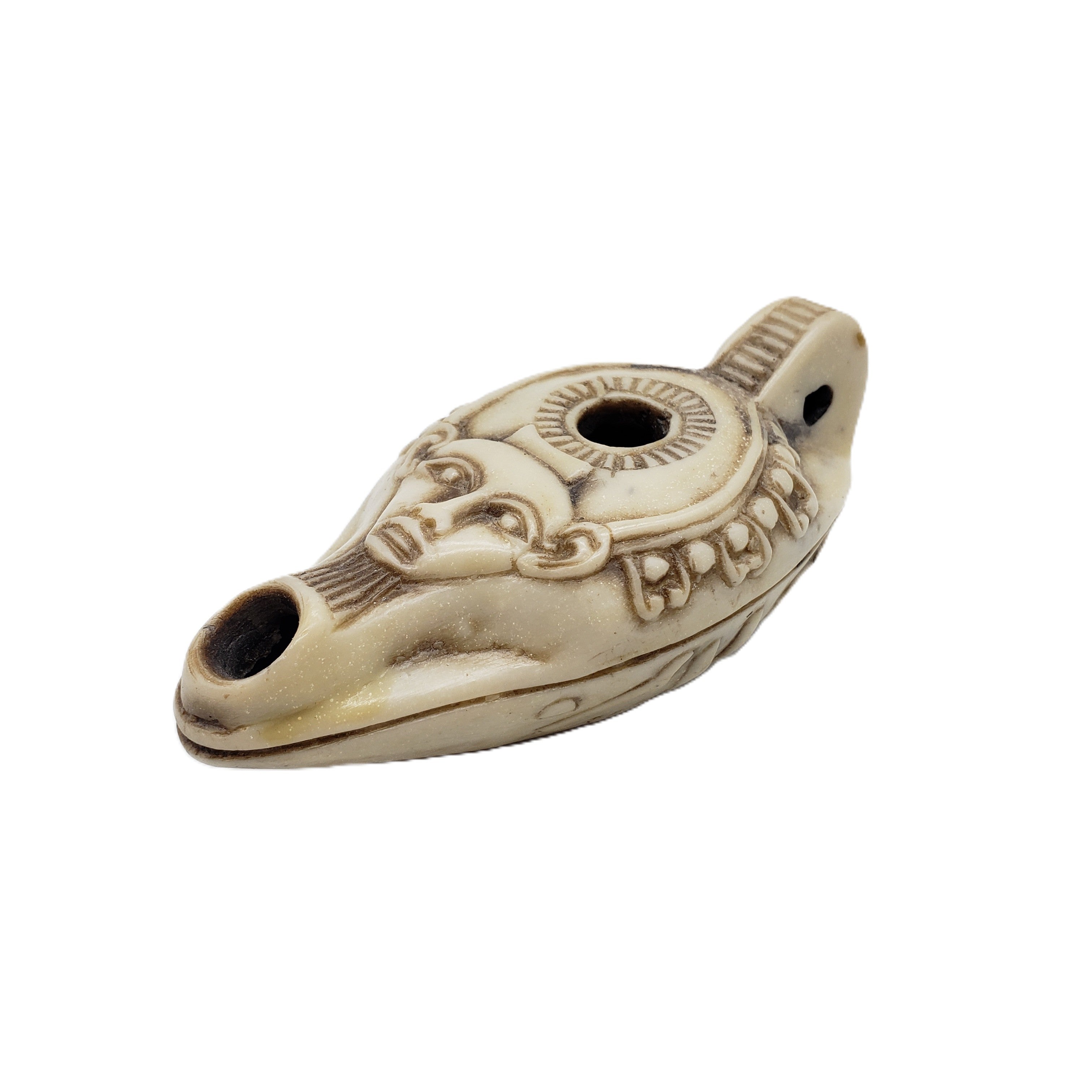 Decorative ceramic oil lamp with intricate designs on a white background