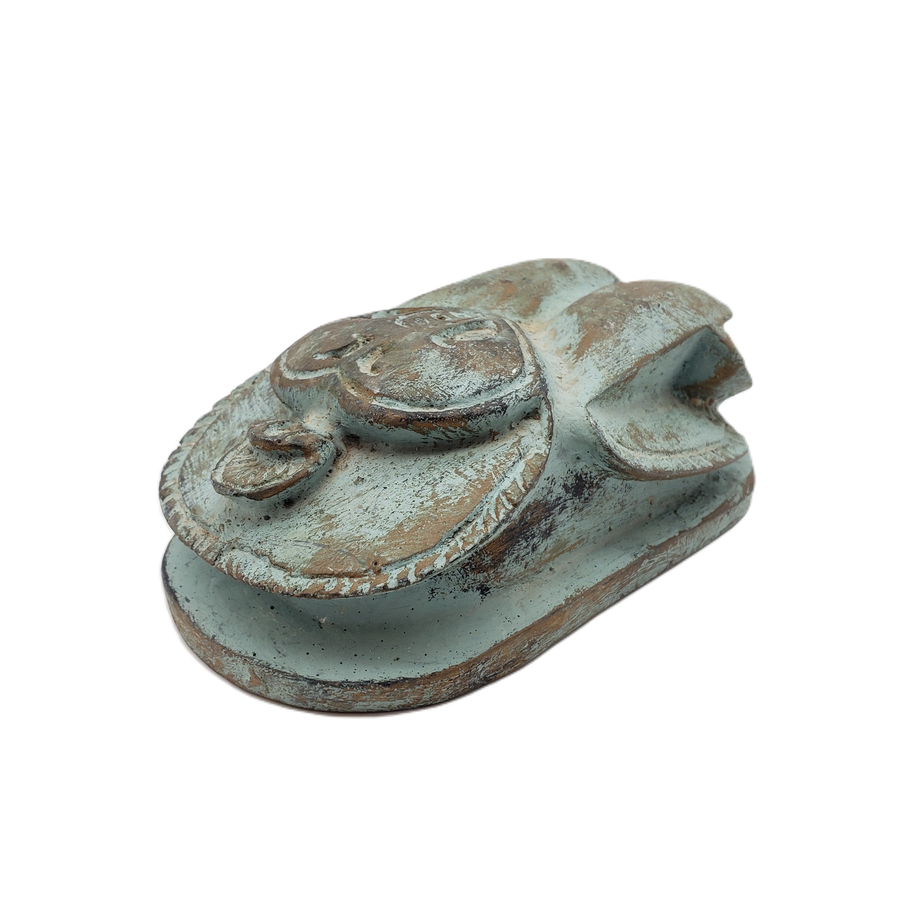 Decorative Egyptian scarab statue with a rustic finish on a white background