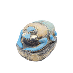 Decorative figurine of a Egyptian scarab statue on a white background