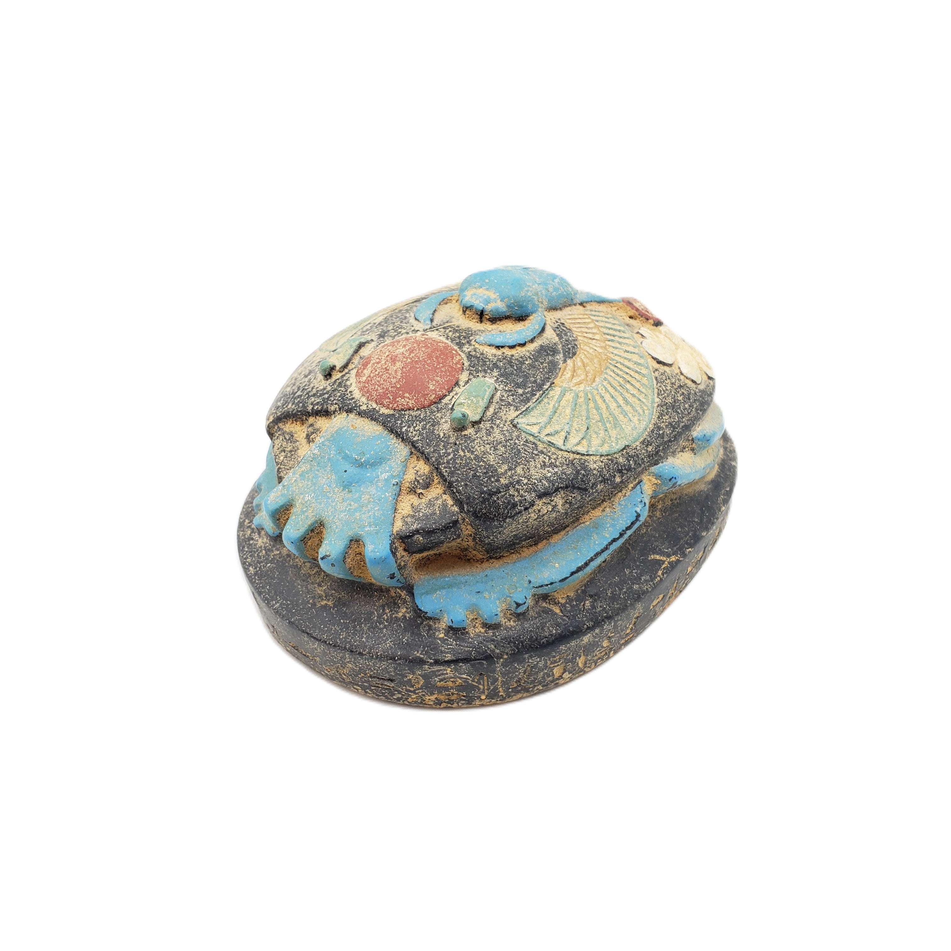 Decorative Egyptian scarab statue on a white background