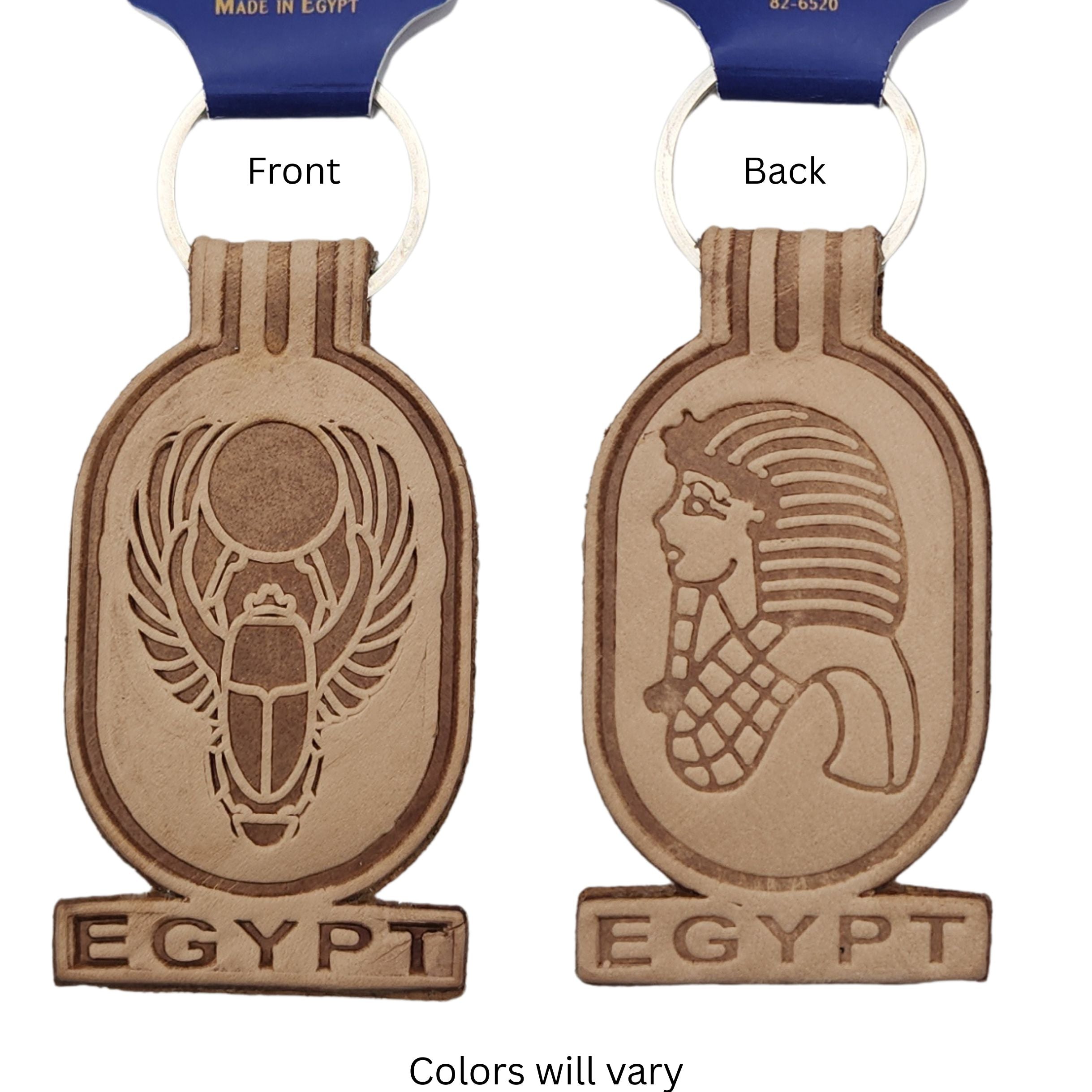 Front and back views of a Egypt-themed keychain, showing engraved scarab beetle and pharaoh designs, on a white background.