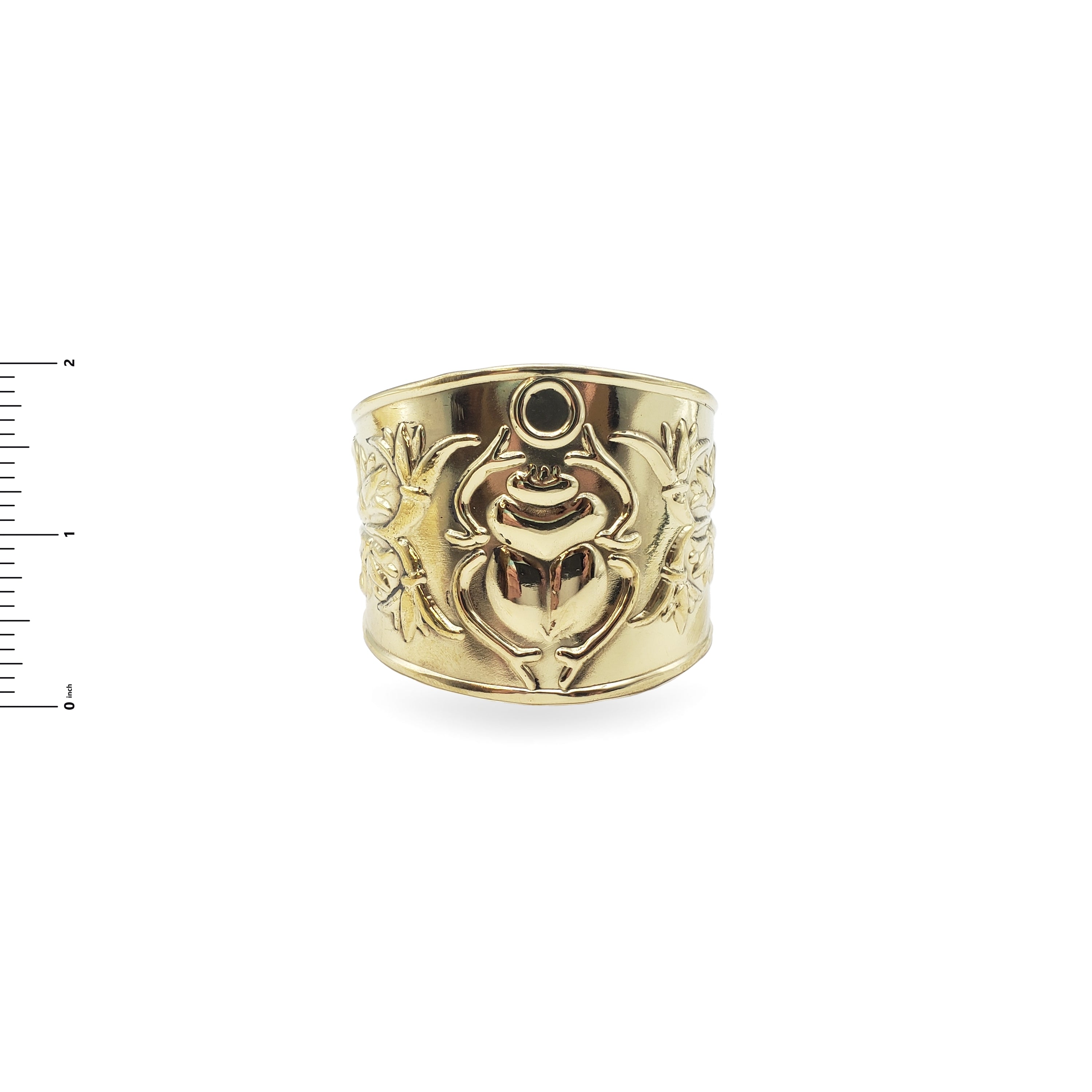 Gold ring with intricate design on a white background