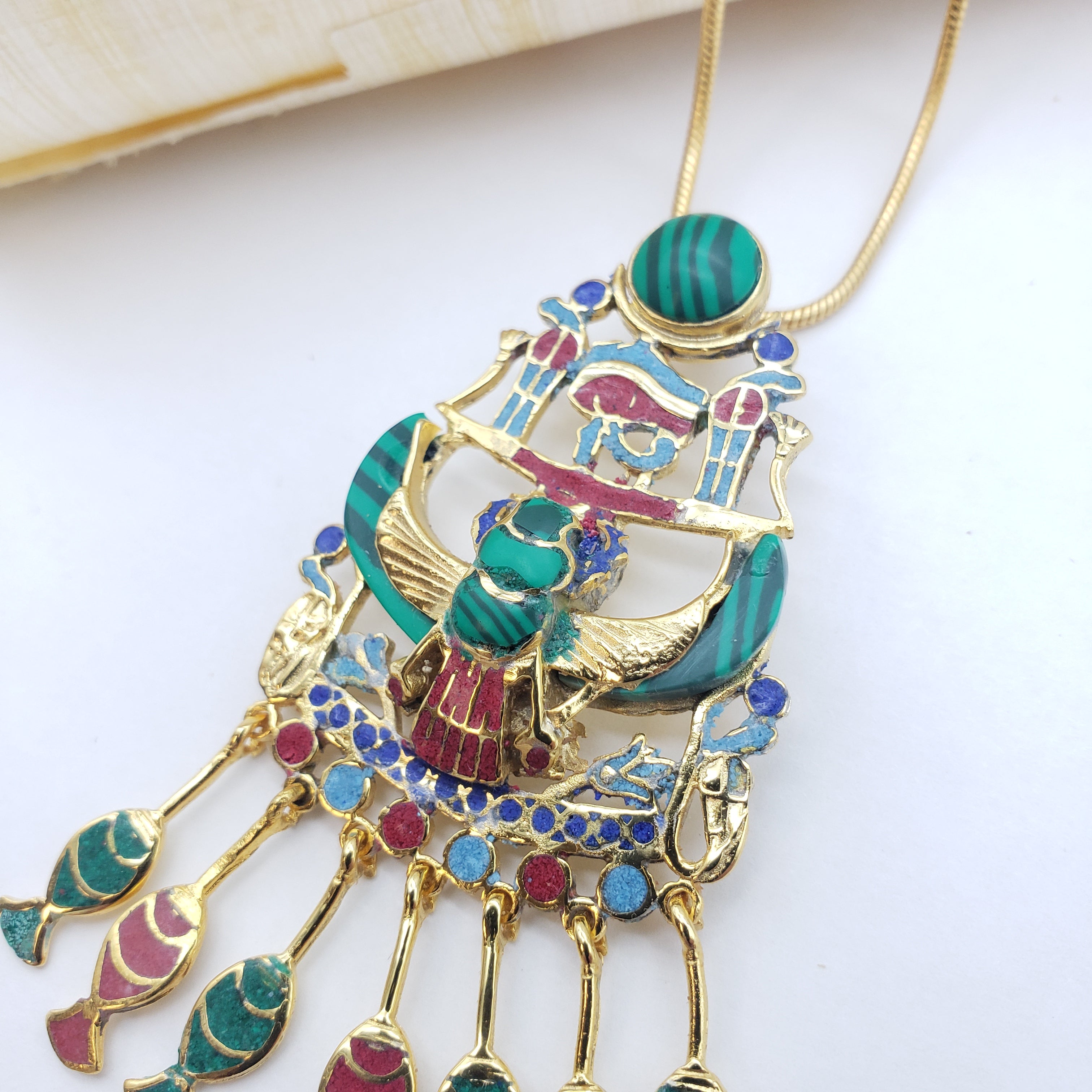 Decorative headband with colorful Egyptian-style design on a white background