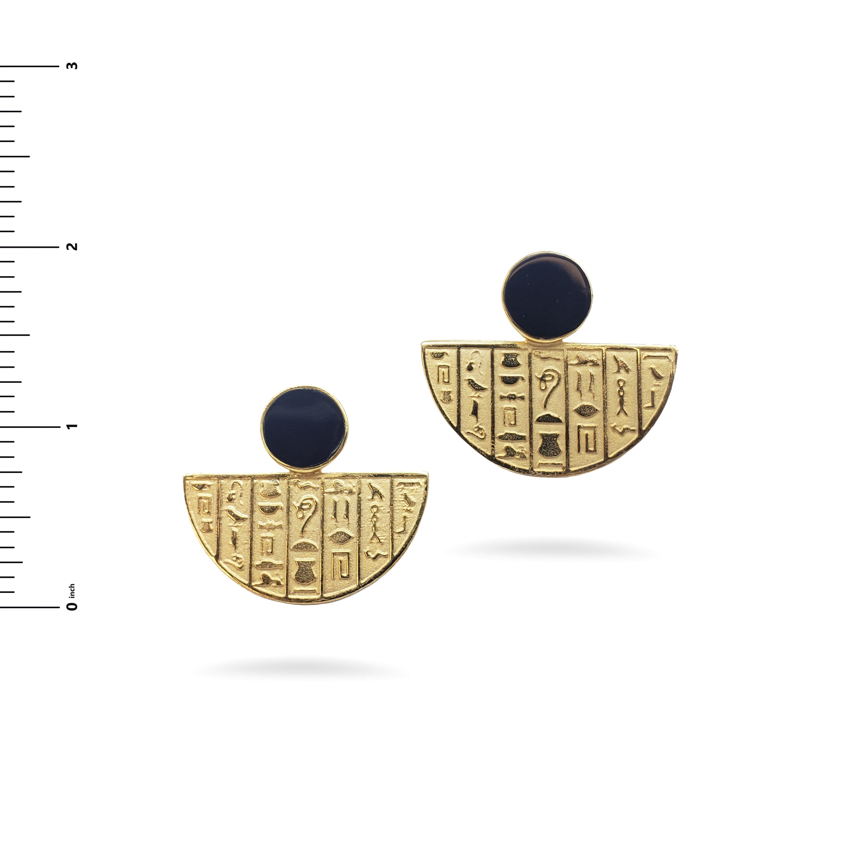 Pair of gold earrings with black stones and hieroglyphic designs on a white background.