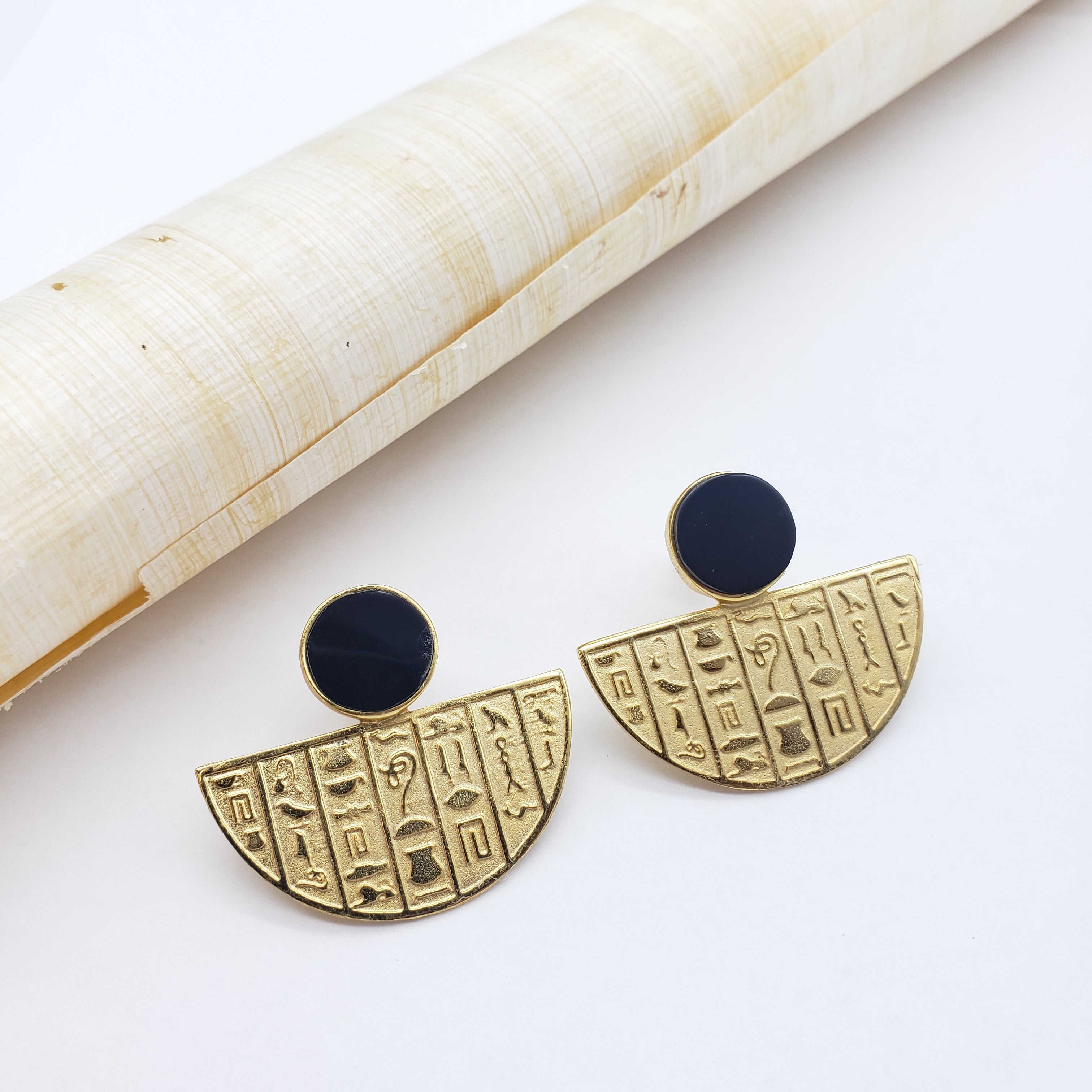 Pair of earrings with hieroglyphic design on a white background