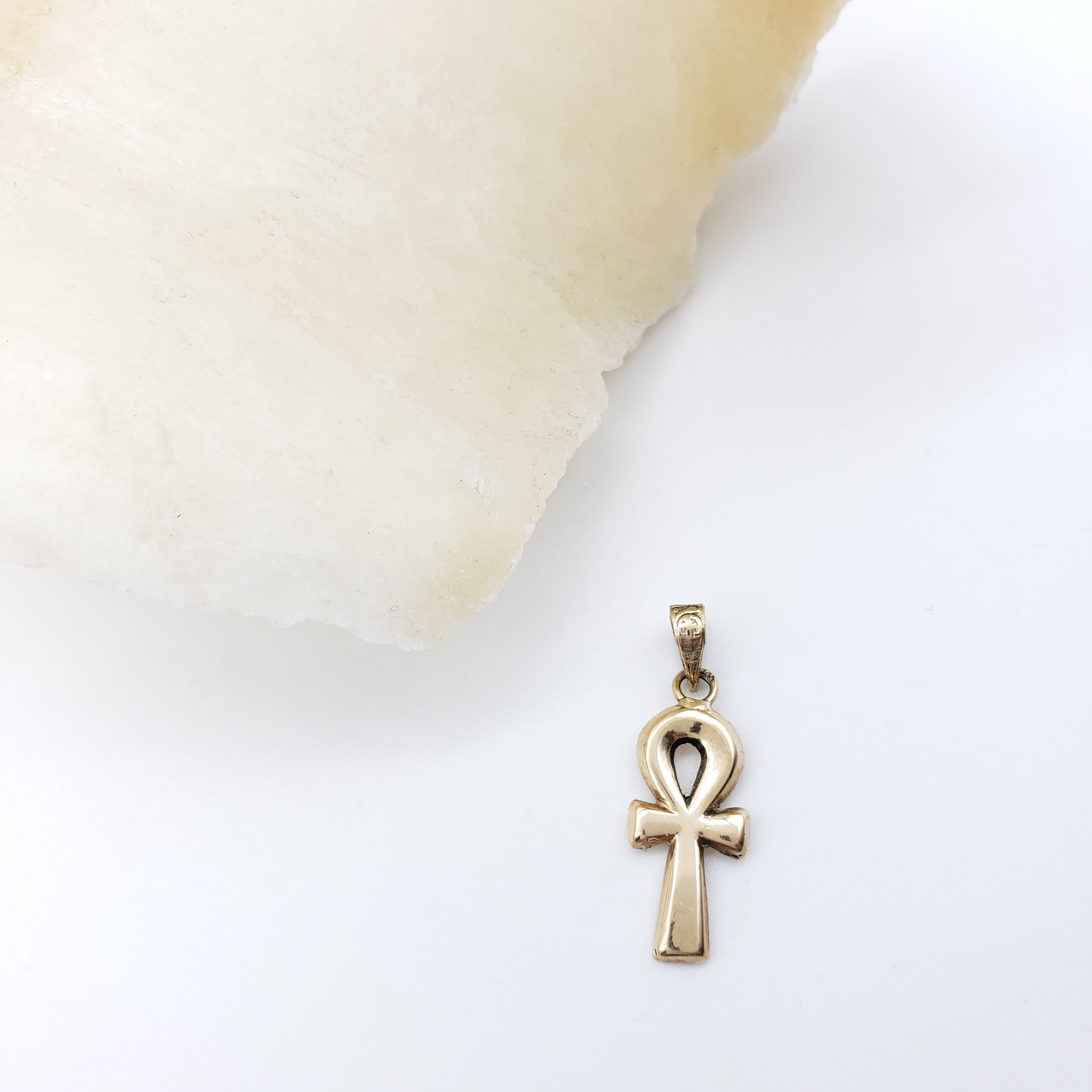 Gold Ankh pendant on a white background