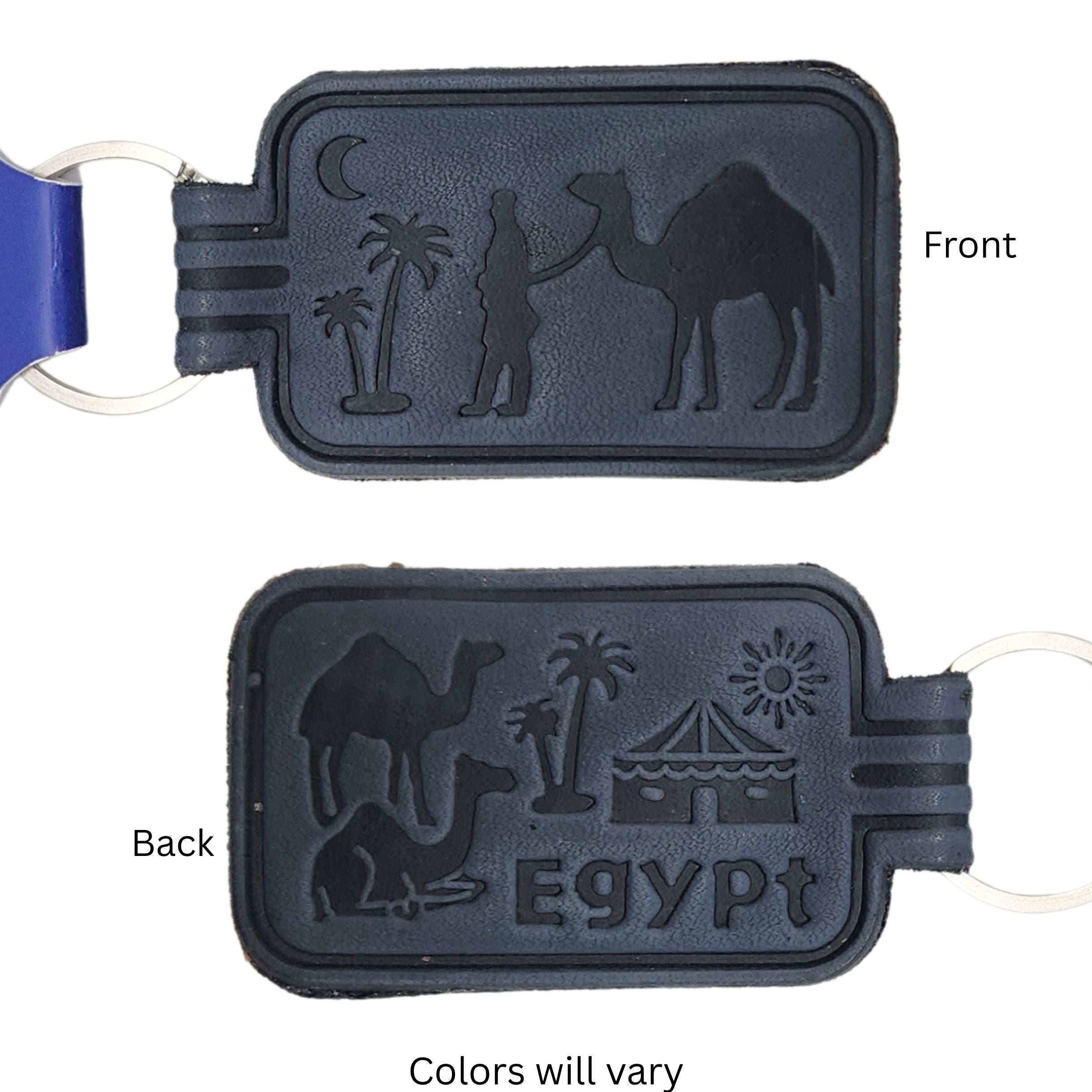 A black faux-leather keychain tag with embossed camel and Egyptian-themed designs, shown from both front and back sides on a white background with text labels.