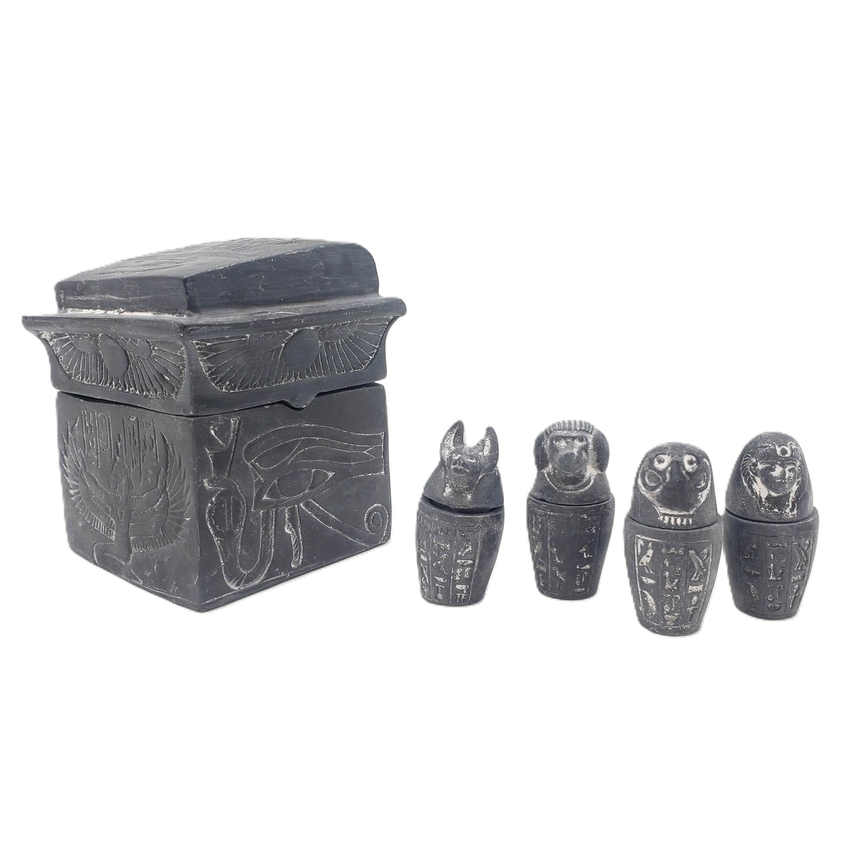 Set of black stone canopic jars with hieroglyphic designs on a white background