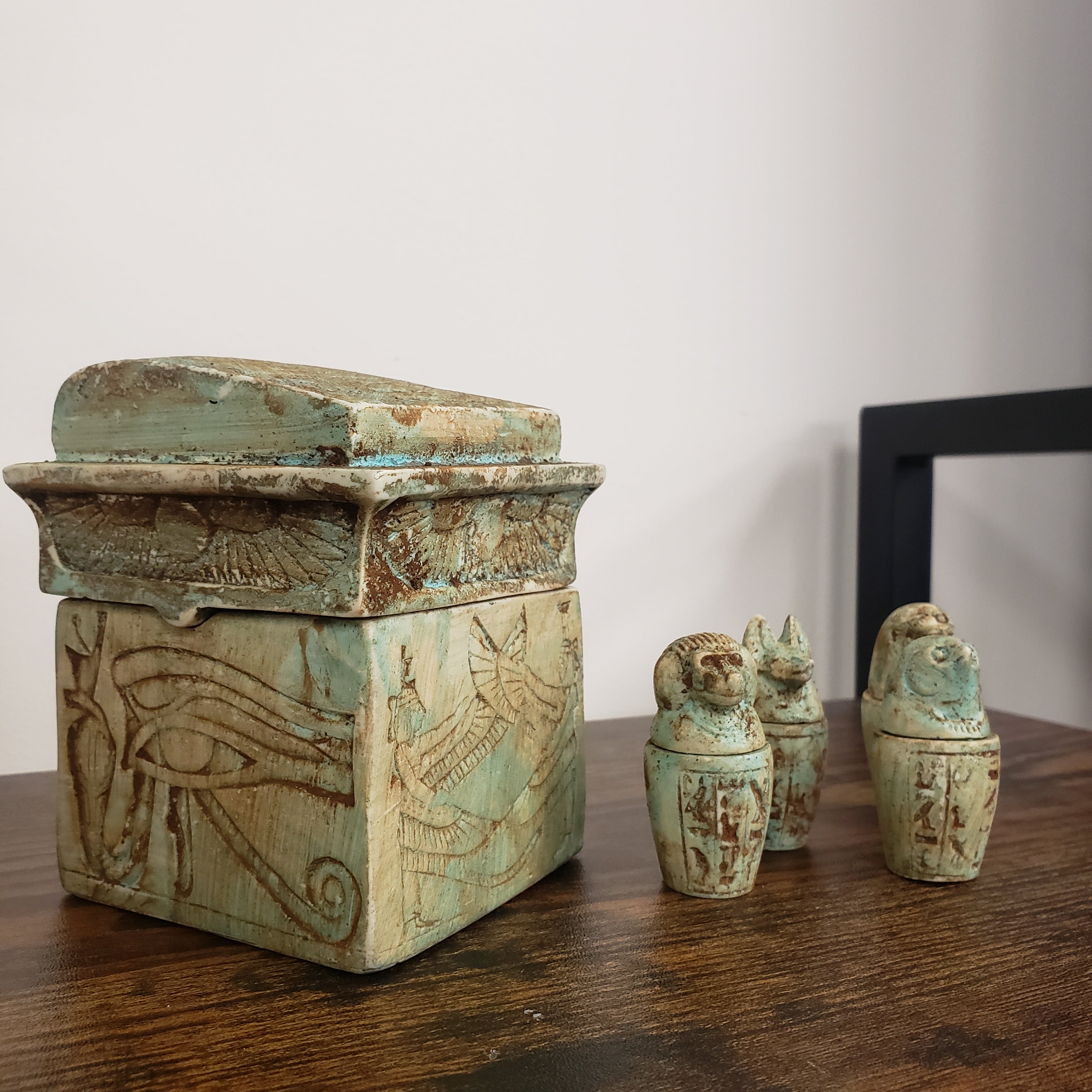 Decorative wooden box with intricate carvings on a wooden surface