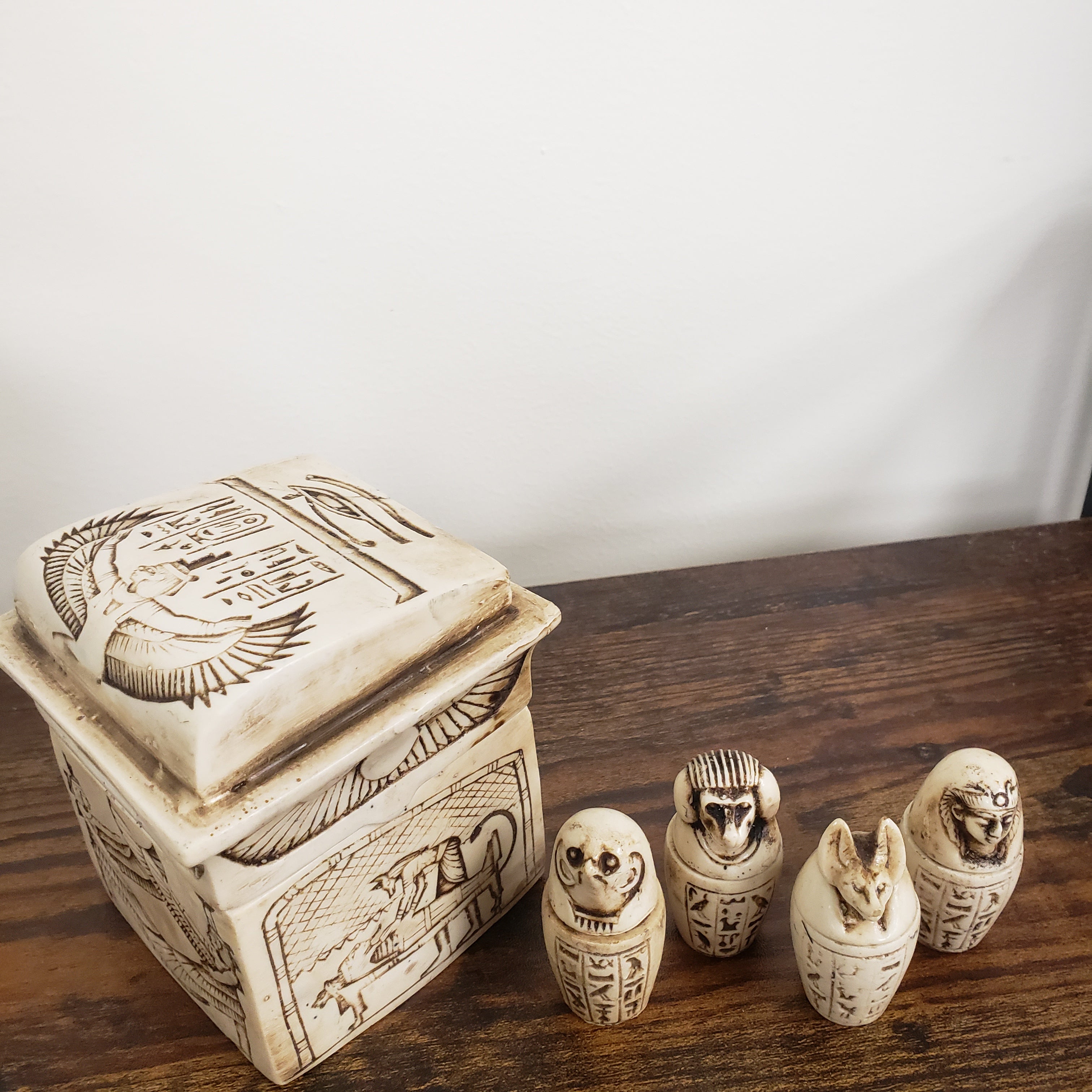 Decorative items with hieroglyphic designs on a wooden surface