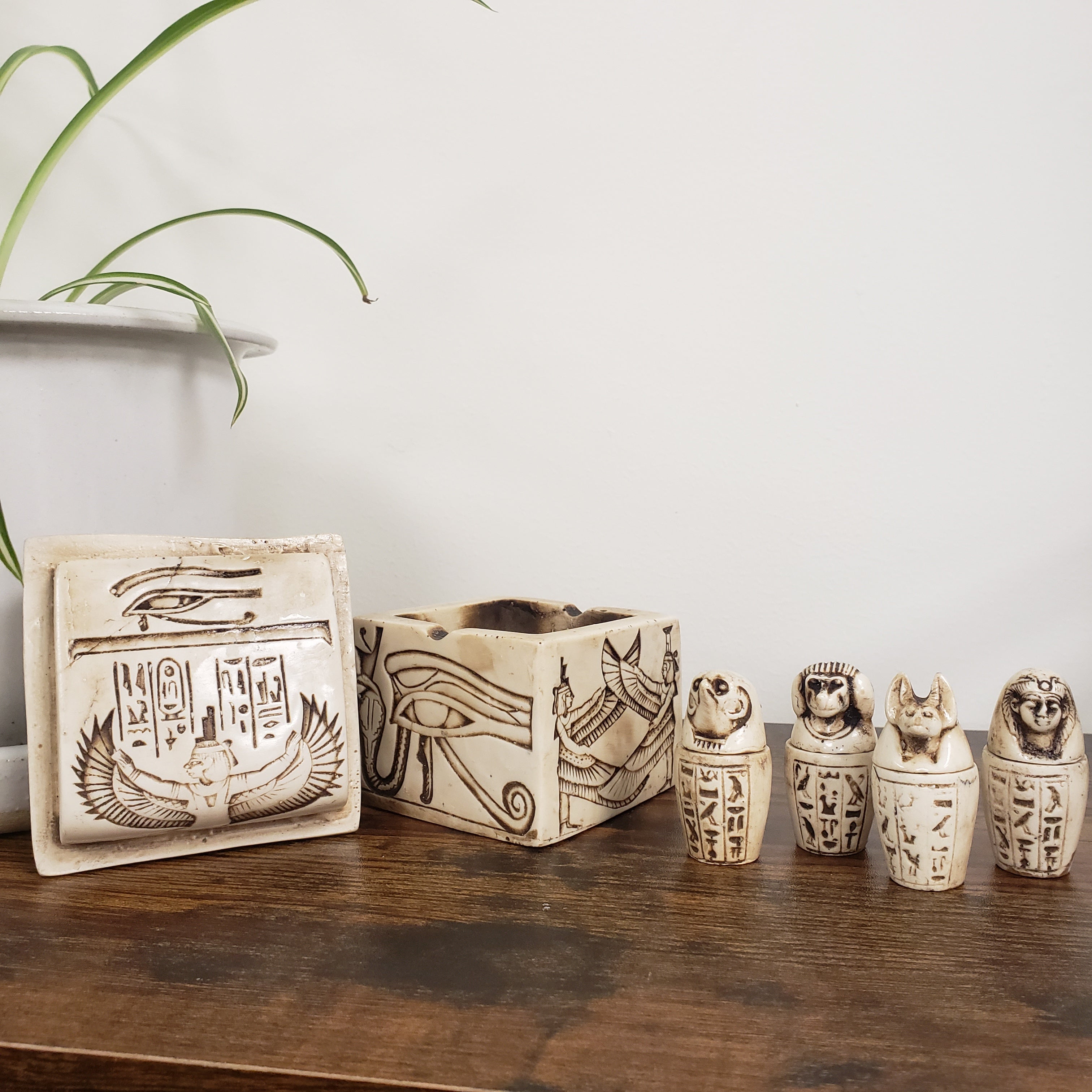 Decorative items with hieroglyphics on a wooden surface