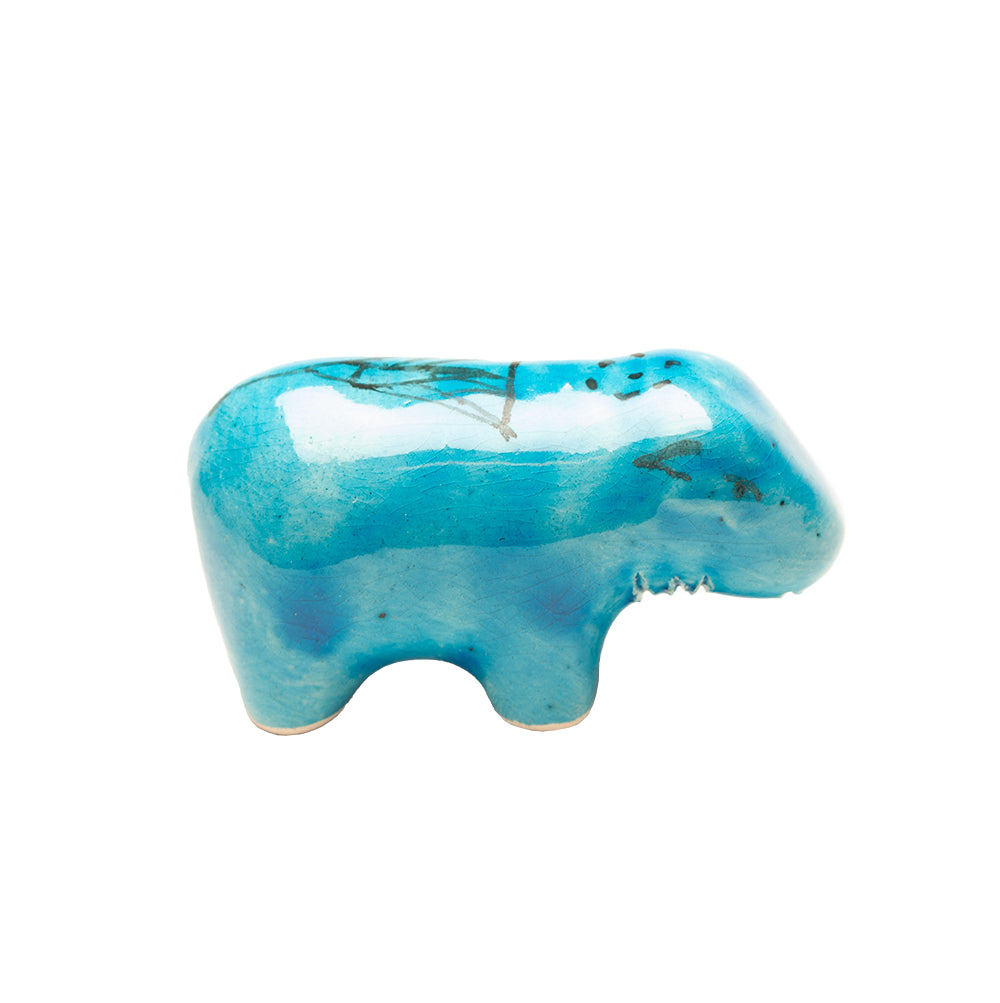 Turquoise ceramic hippo on a white background
