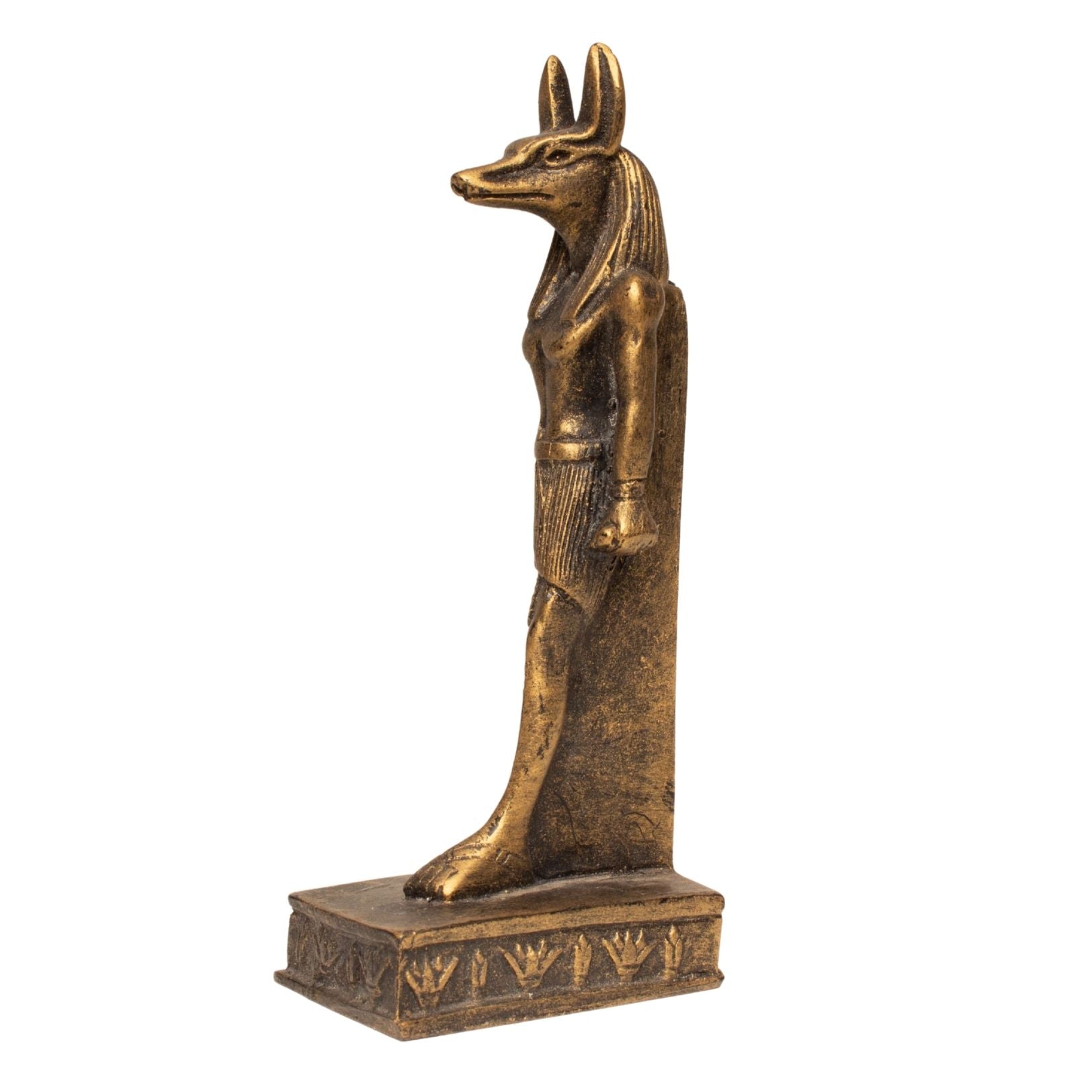 An ancient Egyptian Anubis statue made of bronze-finished metal, standing on a rectangular base with hieroglyphic details, set against a plain white background.