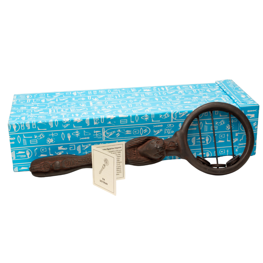 A dark brown Egyptian sistrum rattle, displayed in front of its blue patterned gift box and an instruction card on a white background.