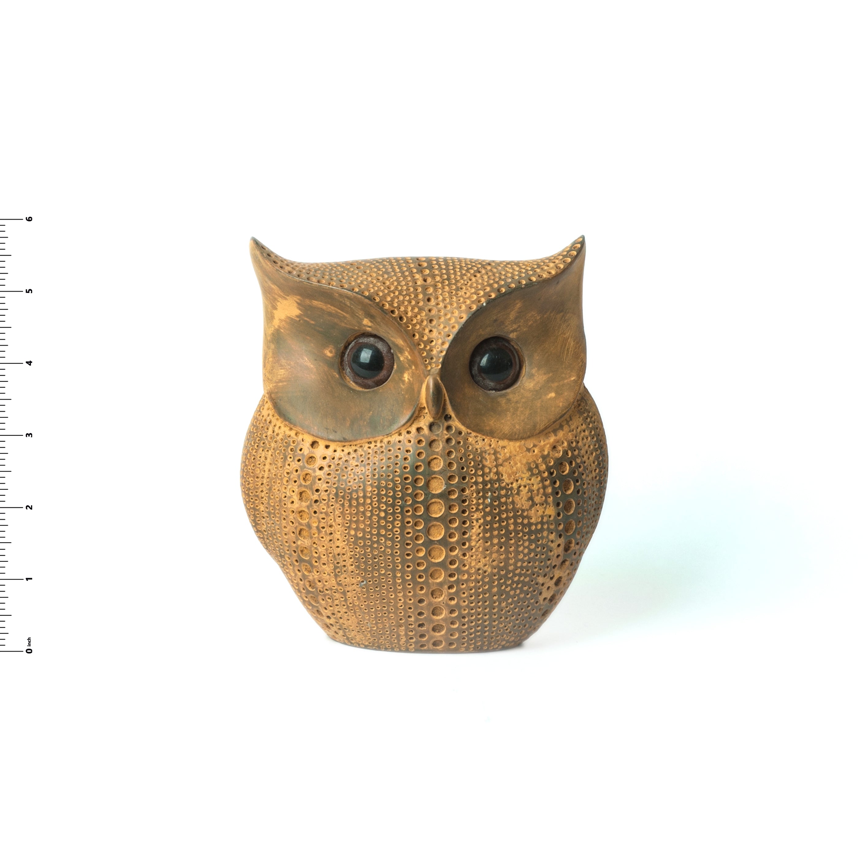 Bronze owl ornament on a white background