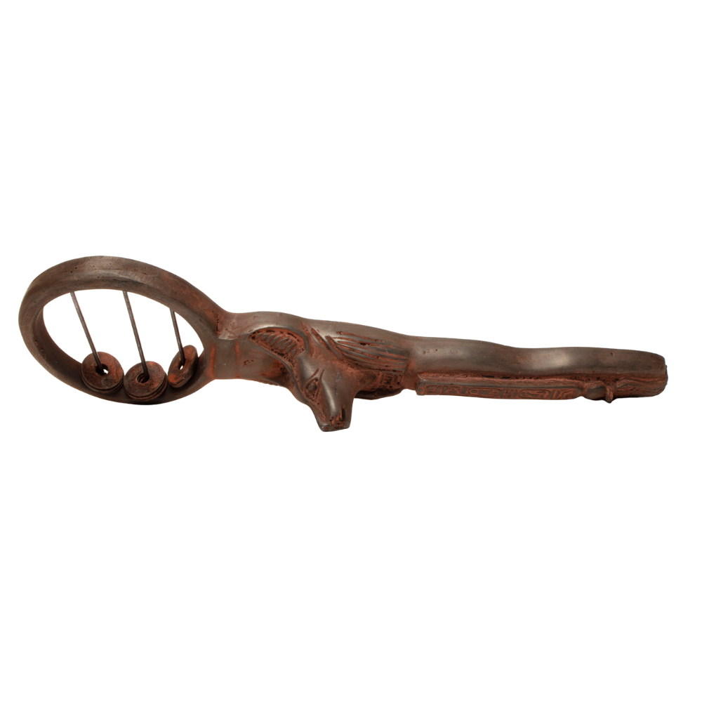 A carved sistrum with a dark brown finish and carved details on the handle, shown against a plain white background.