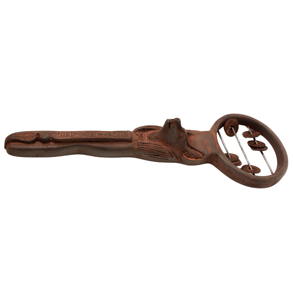 A hand-carved Egyptian sistrum with a rich reddish-brown finish and intricate geometric engravings, shown against a plain white background.