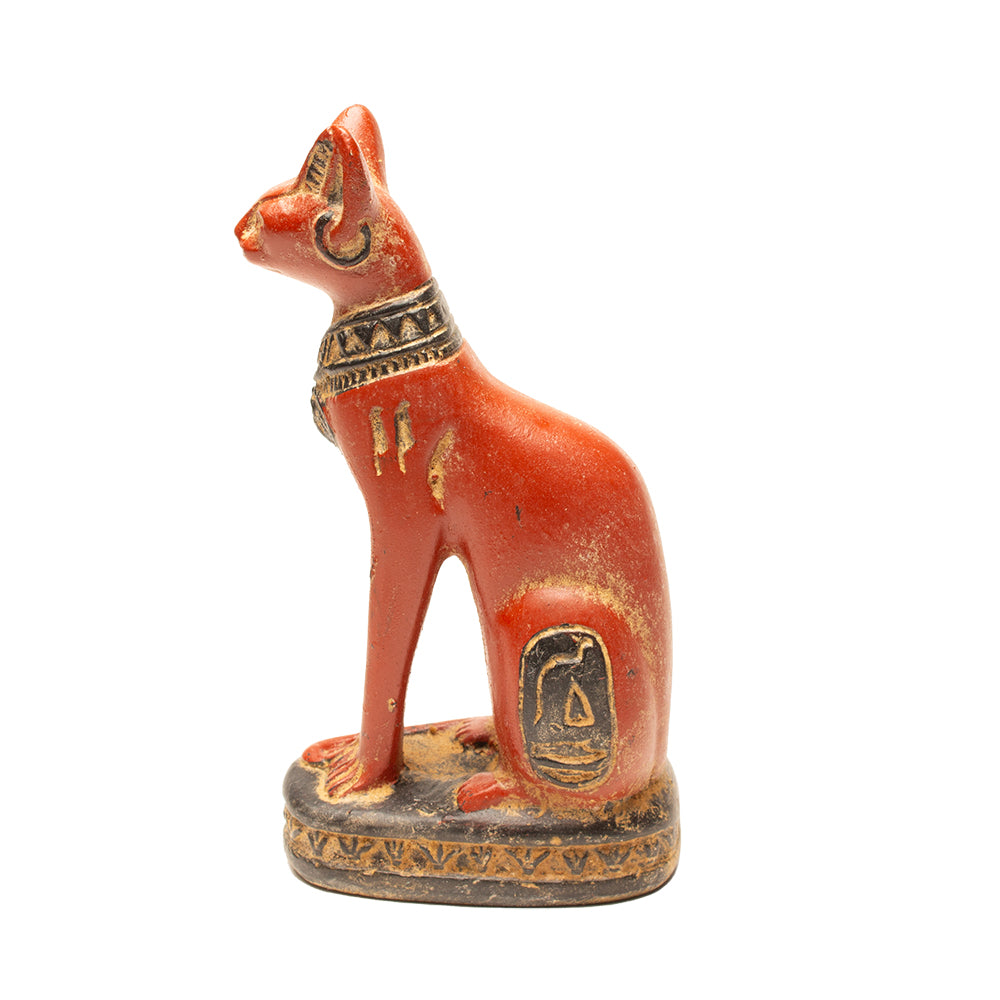 Decorative cat figurine with intricate designs on a white background