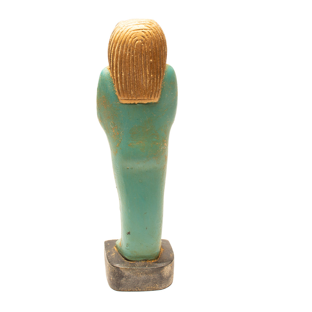 Decorative item with gold head and green body on a white background