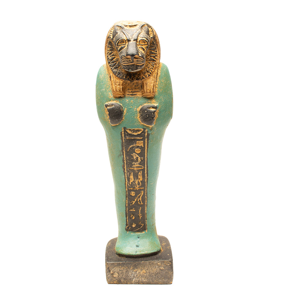 Decorative item resembling an ancient Egyptian ushabti with a lion head on a white background