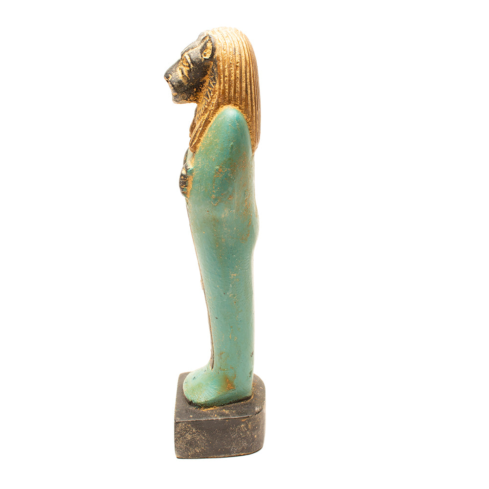 Statue of a figure with a gold head and turquoise body on a white background