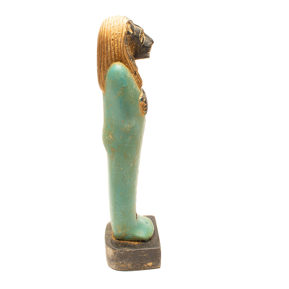 Statue of a figure with a turquoise body and gold head on a white background