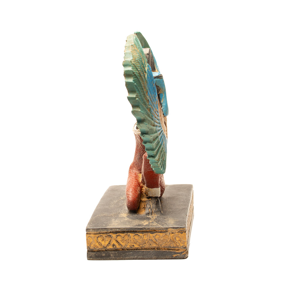 Decorative item with a large circular plate on a stand against a white background