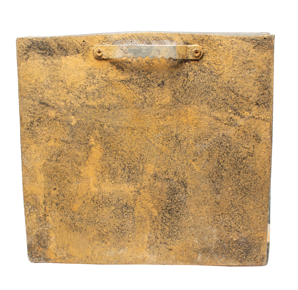 Rust-colored metal box with a handle on a white background