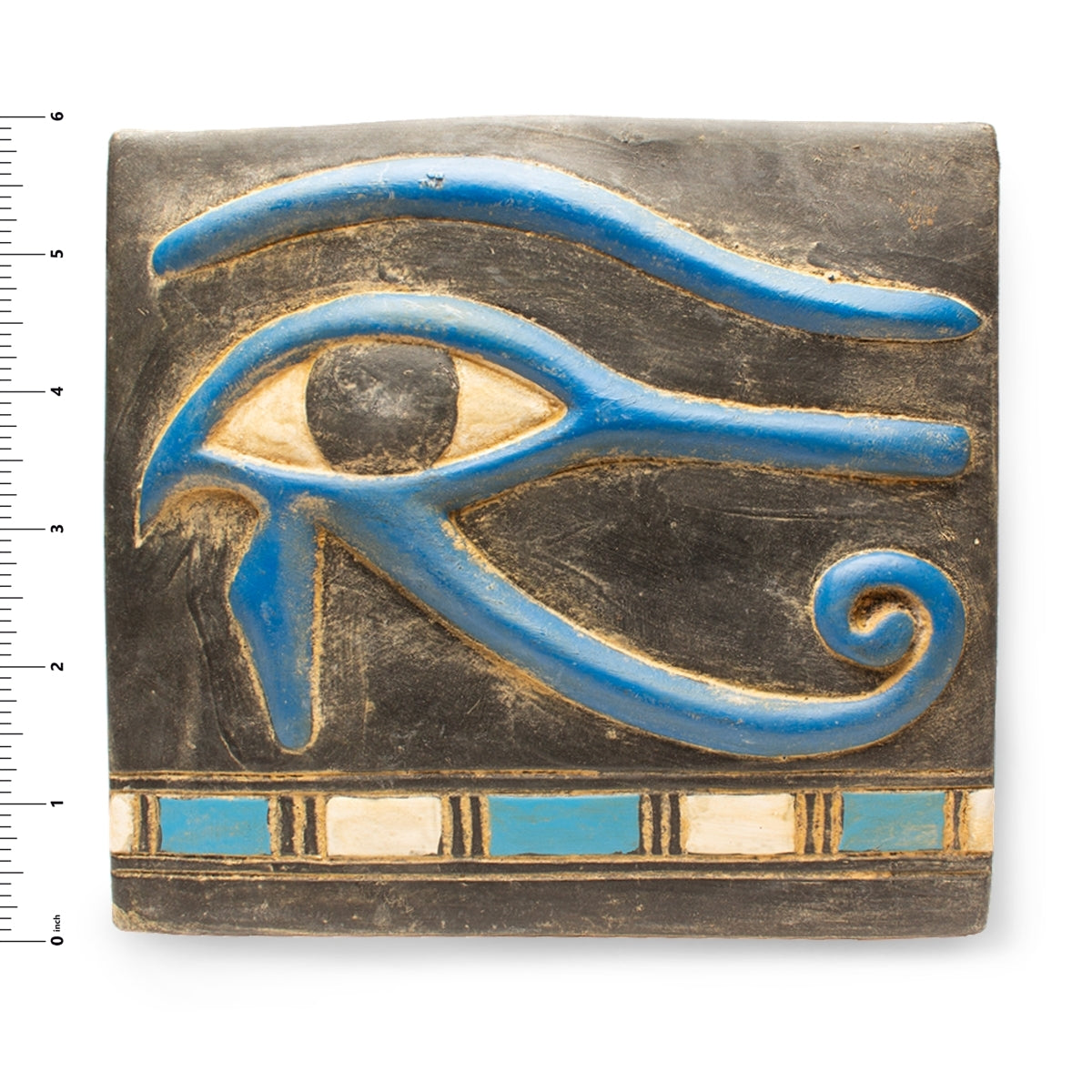 Decorative plaque with an eye design on a white background