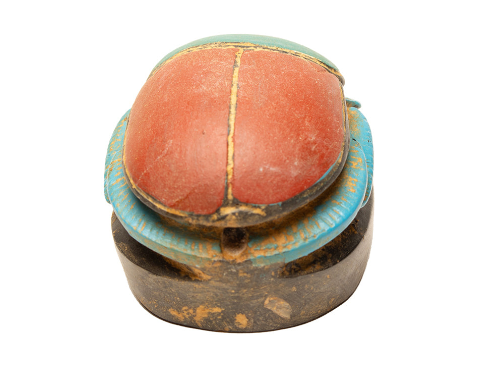 Vintage-style wooden box with a red top and blue sides on a white background