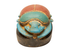 Ancient Egyptian scarab beetle amulet on a white background
