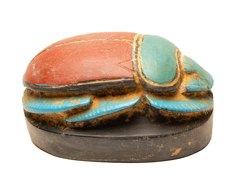 Decorative box shaped like a beetle with colorful paint on a white background